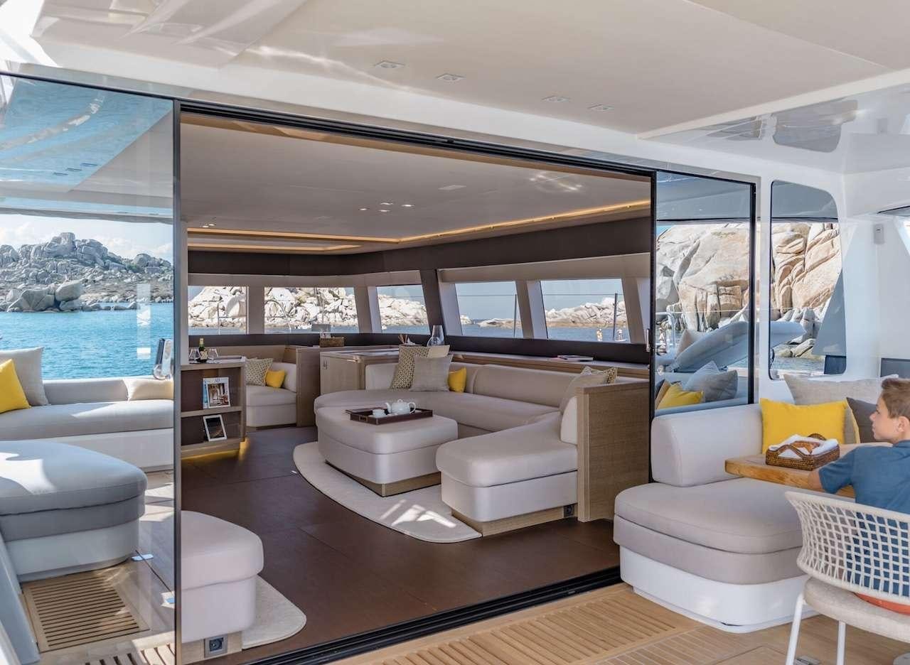 a living room with a large window aboard AEOLUS 77 Yacht for Charter