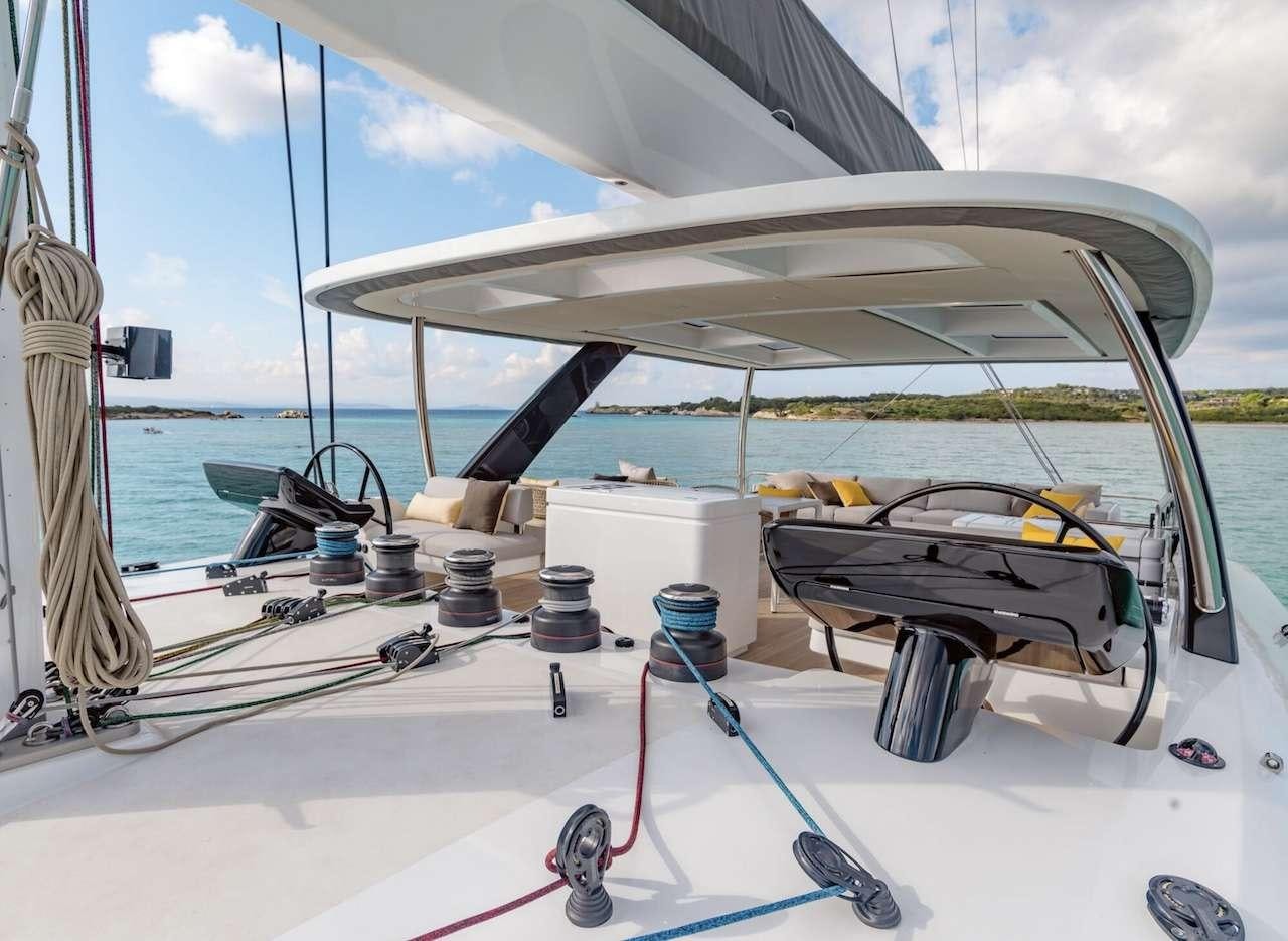 a boat with a large white sail aboard AEOLUS 77 Yacht for Charter