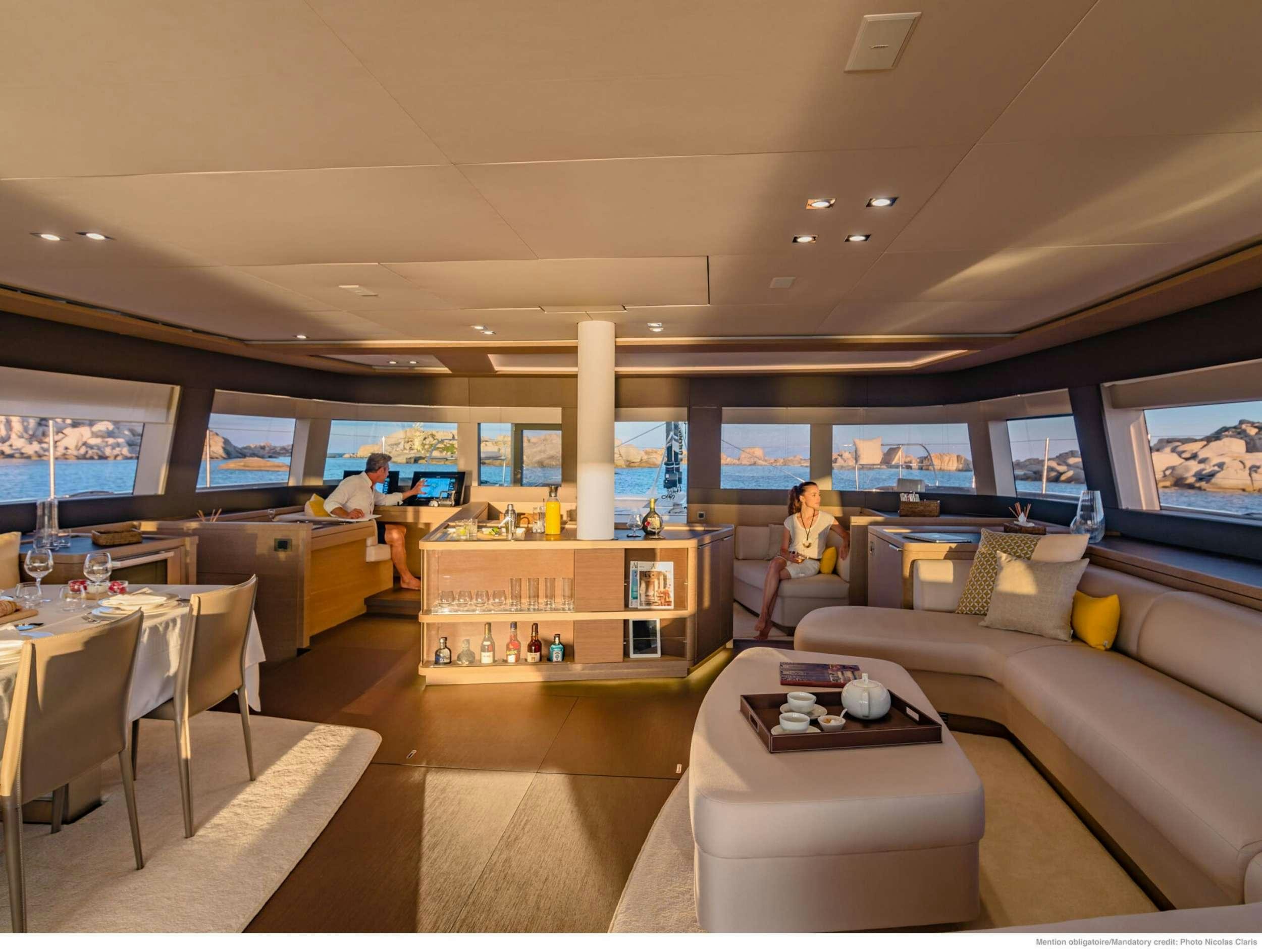 a room with a couch and a tv aboard AEOLUS 77 Yacht for Charter