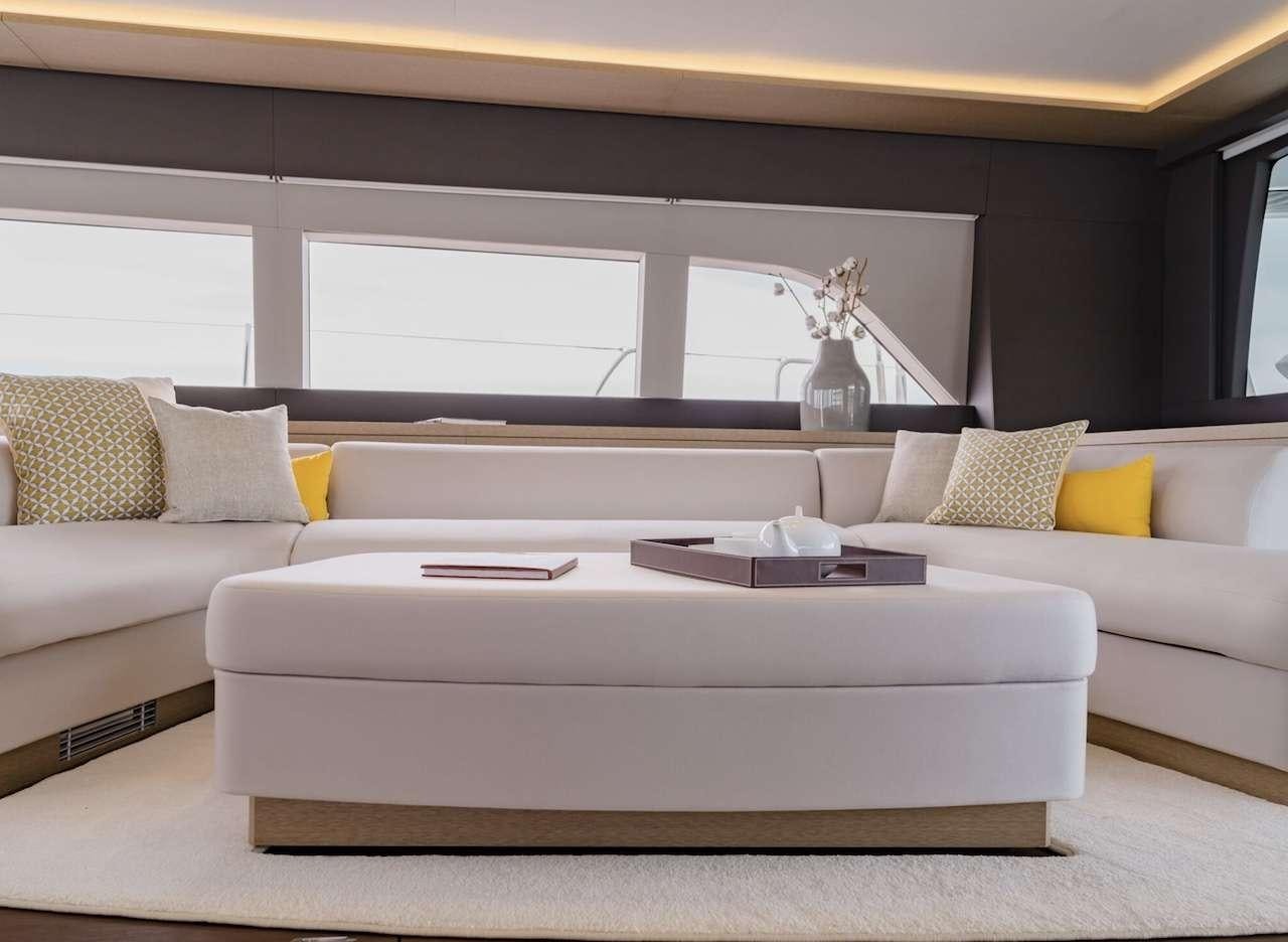 a couch with a coffee table aboard AEOLUS 77 Yacht for Charter