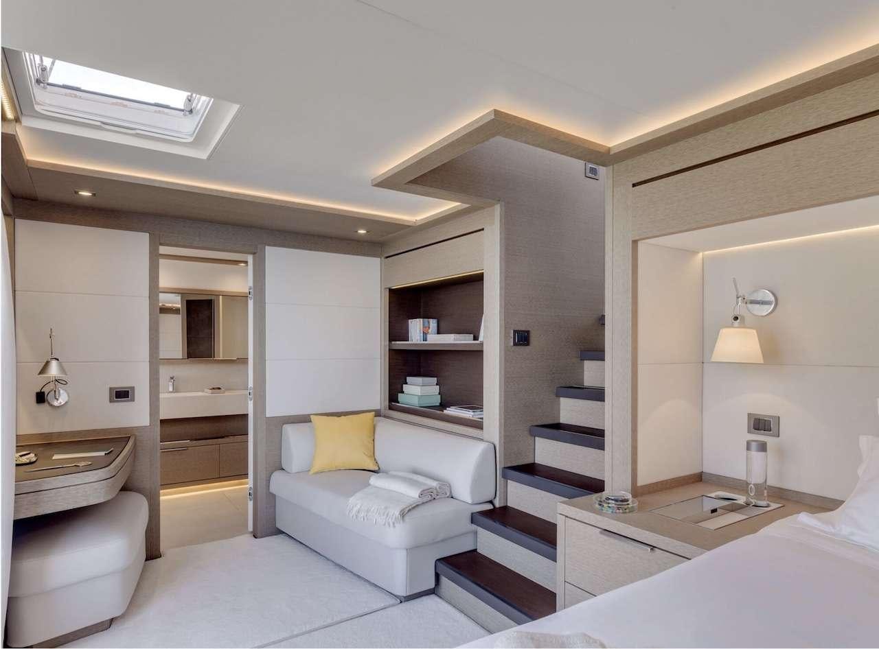 a room with a bed and a desk aboard AEOLUS 77 Yacht for Charter