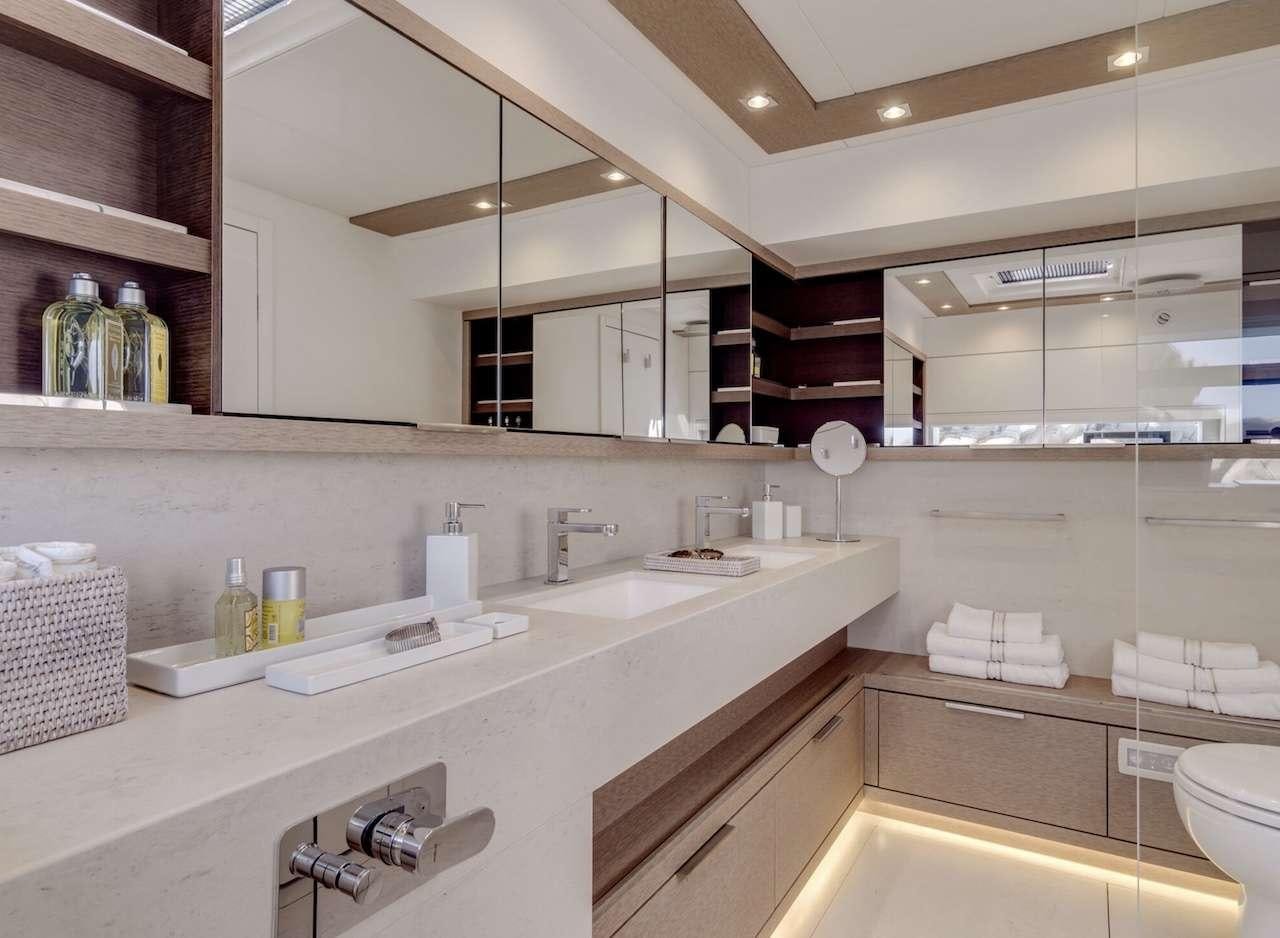 a bathroom with a sink and a shelf of towels aboard AEOLUS 77 Yacht for Charter