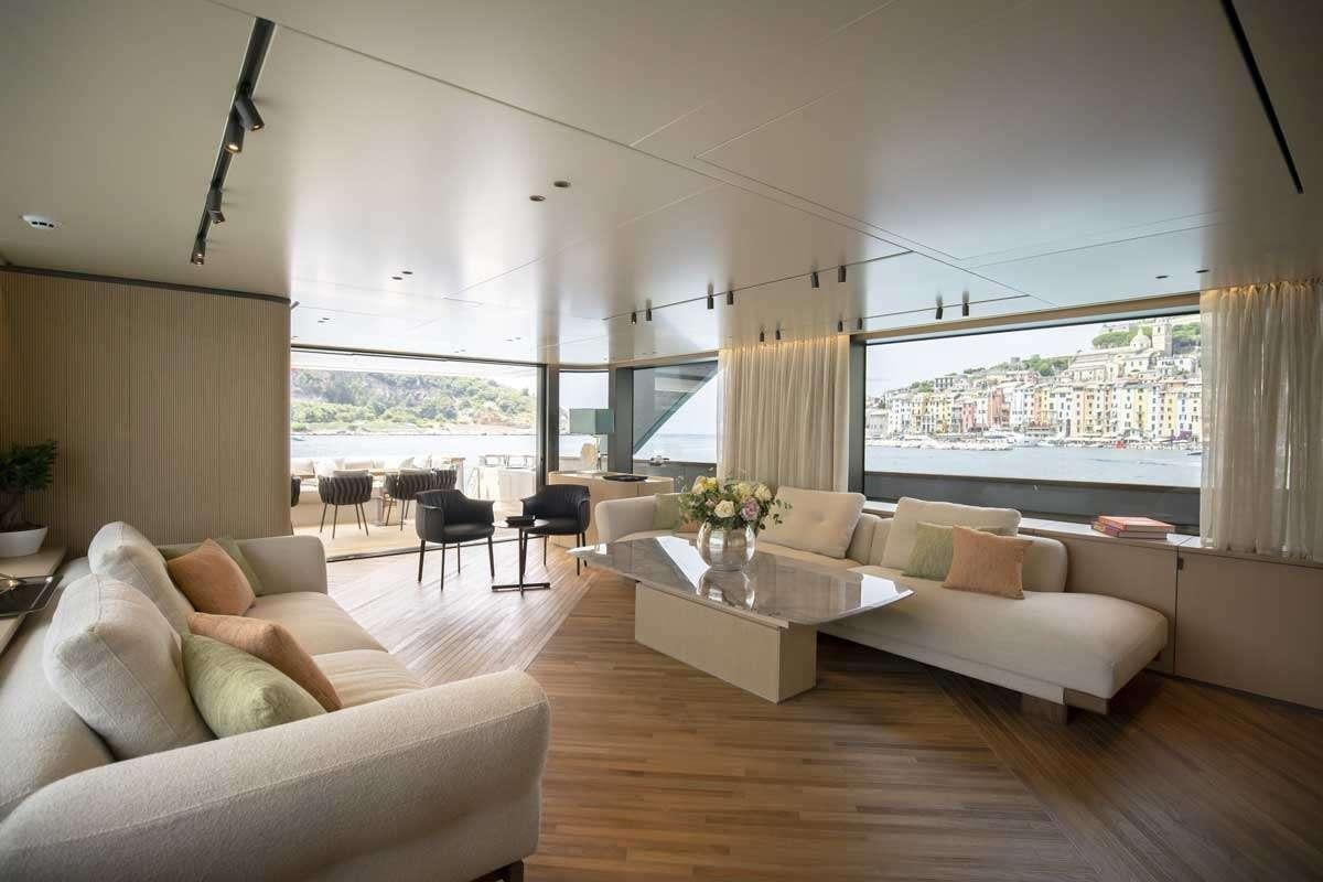 a living room with a large window aboard EM3 Yacht for Charter