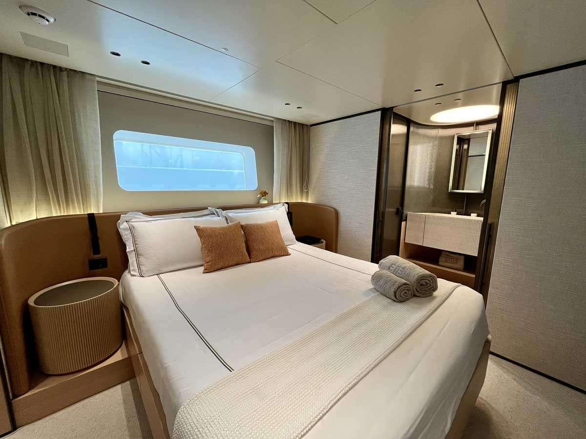 a hotel room with a bed and a chair aboard EM3 Yacht for Charter