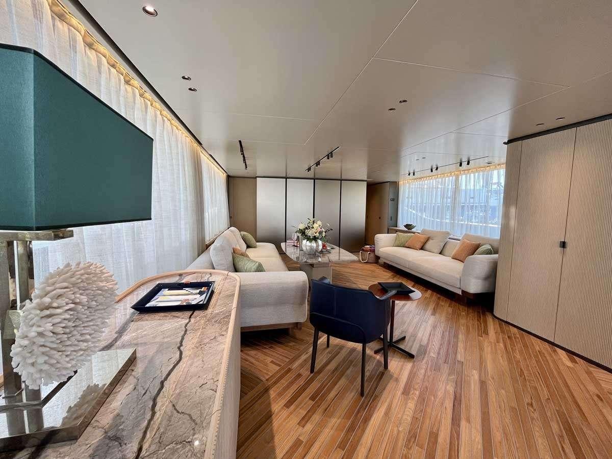 a living room with a couch and a table aboard EM3 Yacht for Charter