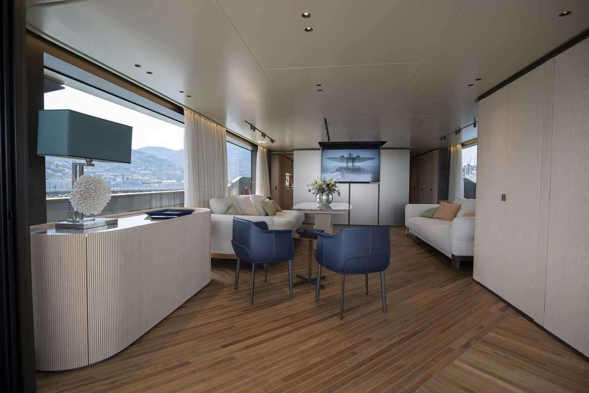 a living room with a large window aboard EM3 Yacht for Charter