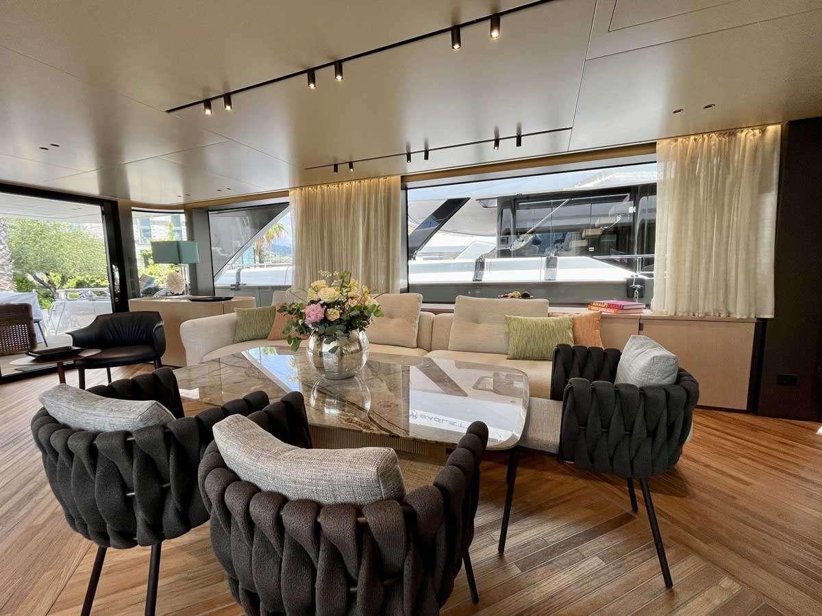 a living room with a large window aboard EM3 Yacht for Charter