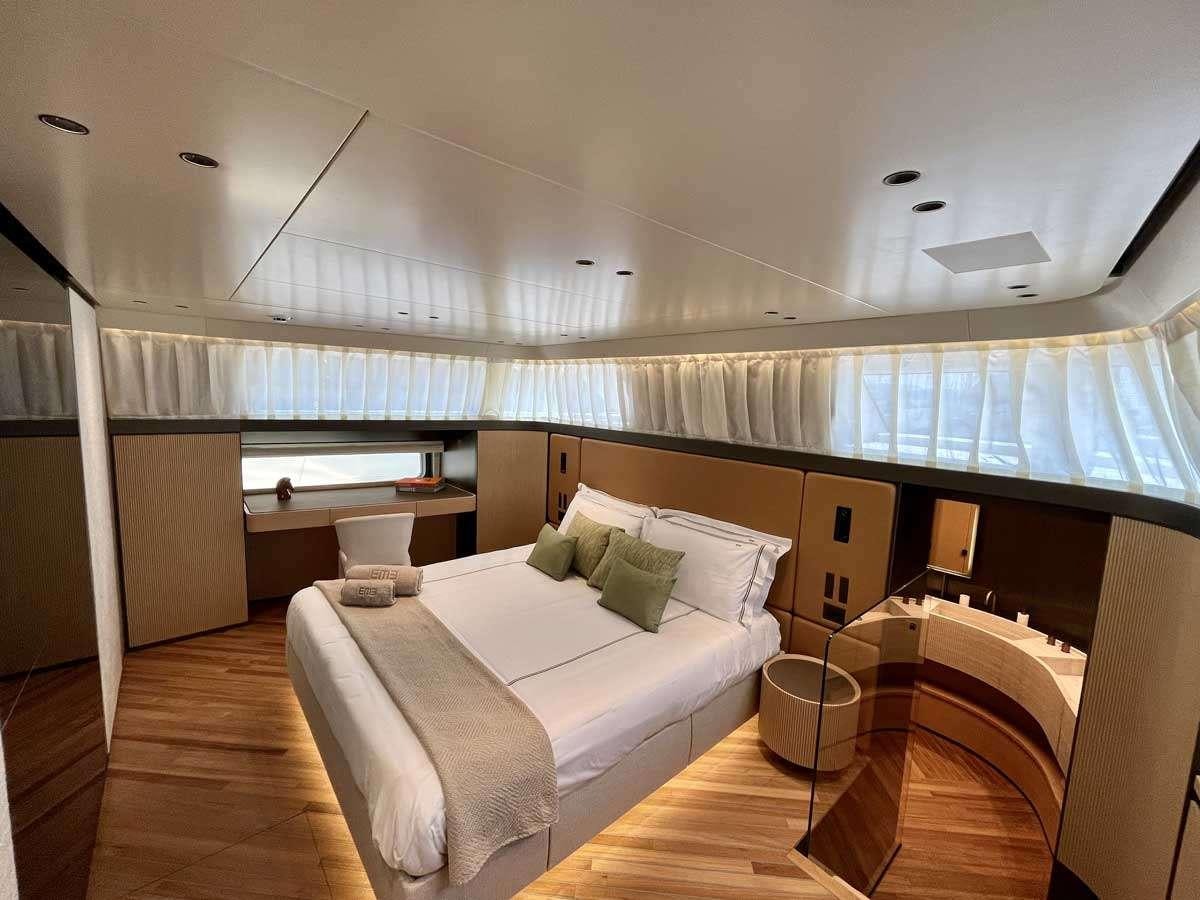 a room with a bed and a desk aboard EM3 Yacht for Charter