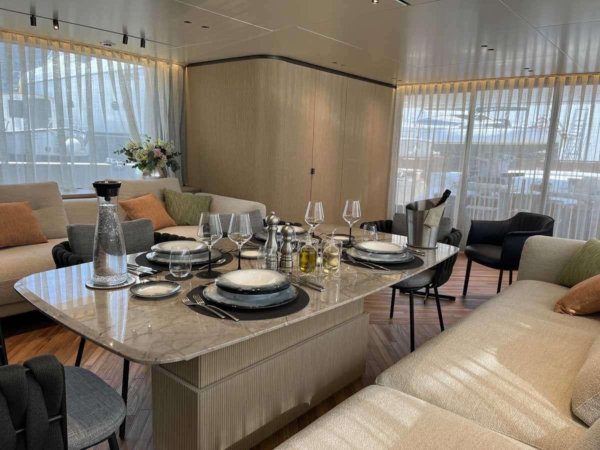 a dining room with a table set aboard EM3 Yacht for Charter