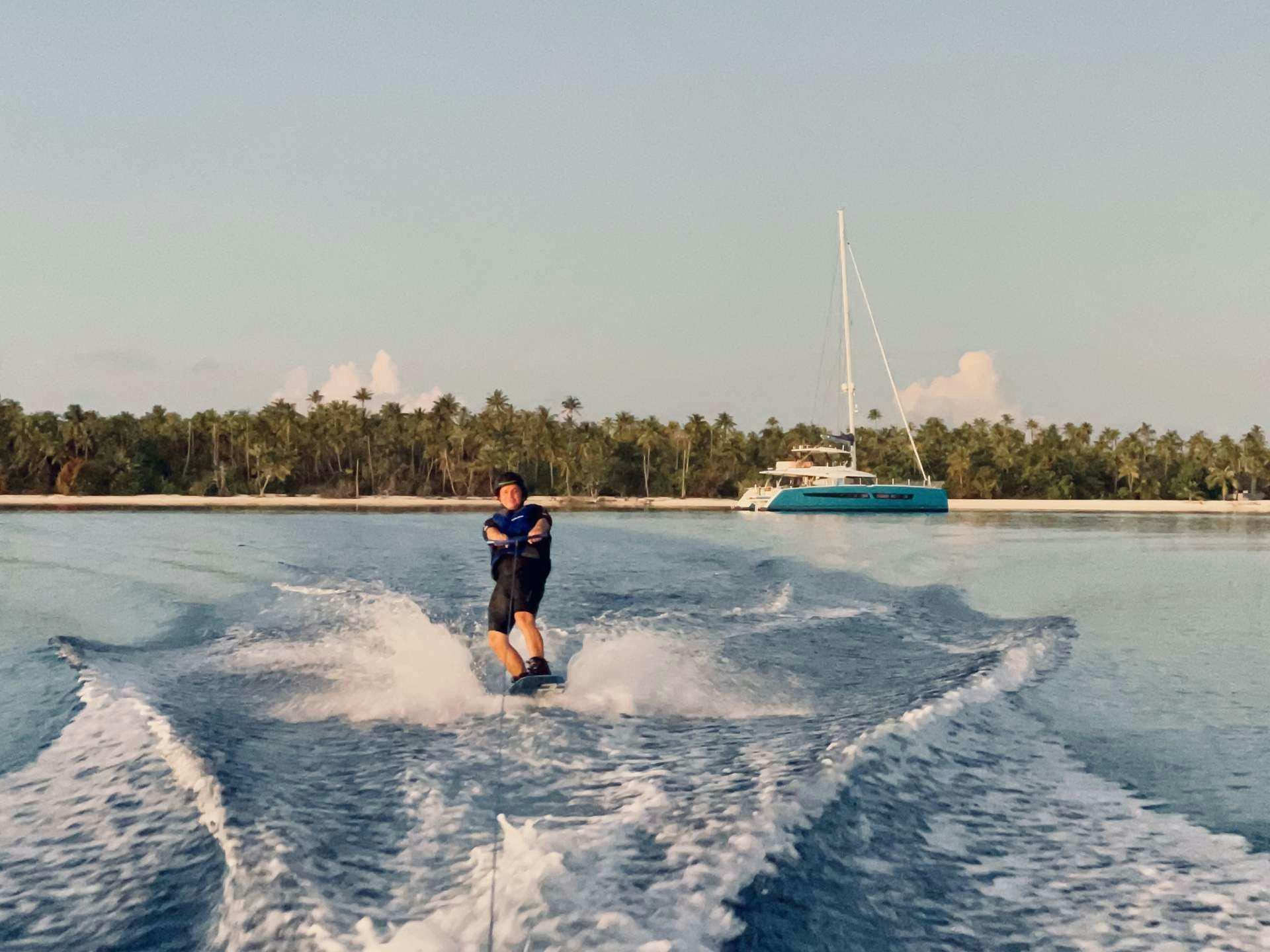 a man water skiing aboard YELLOW Yacht for Charter
