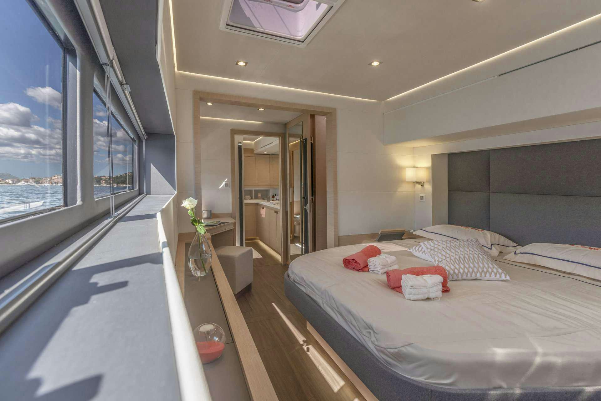 a room with a bed and a window aboard YELLOW Yacht for Charter