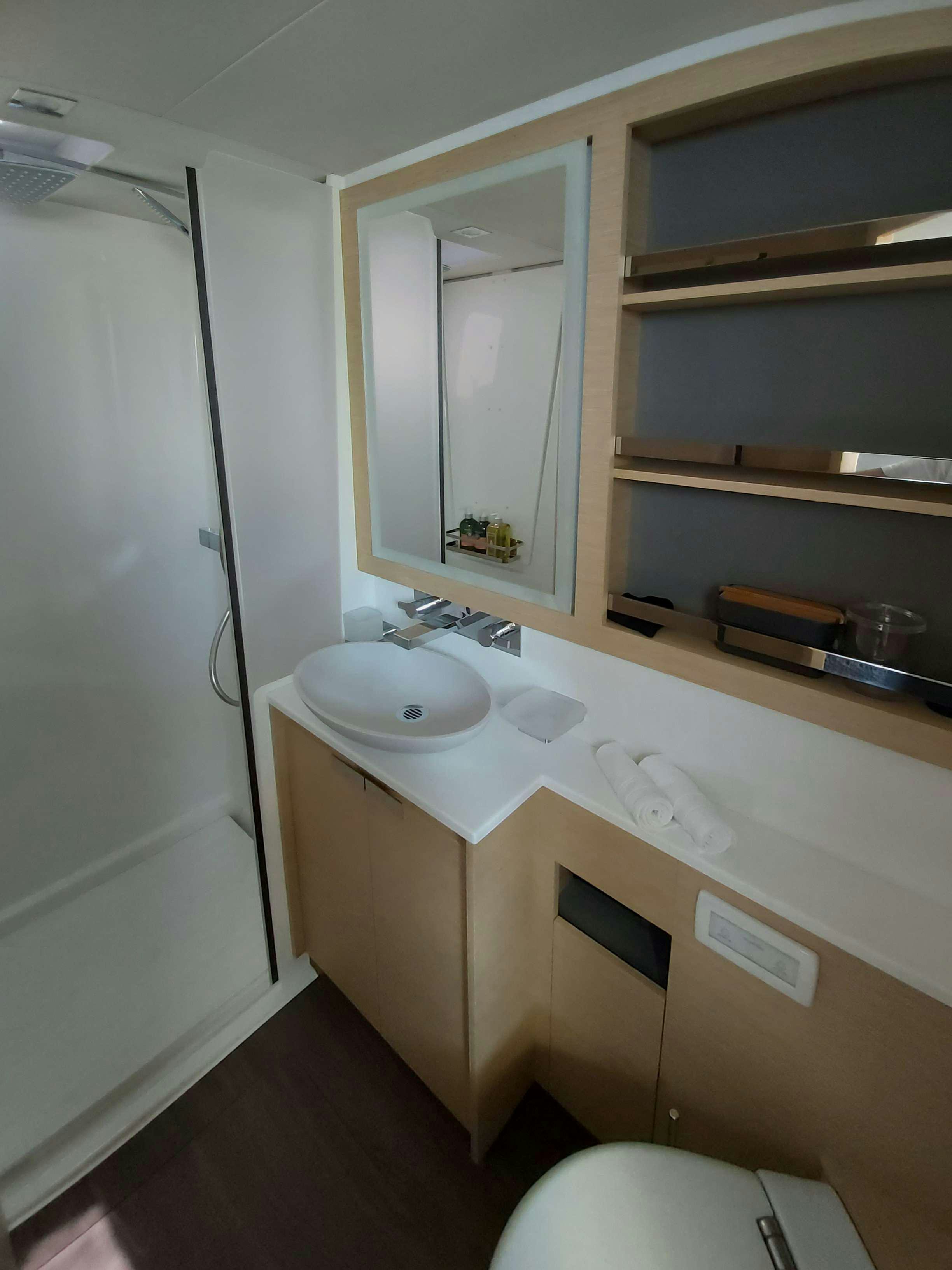 a bathroom with a sink and a mirror aboard YELLOW Yacht for Charter