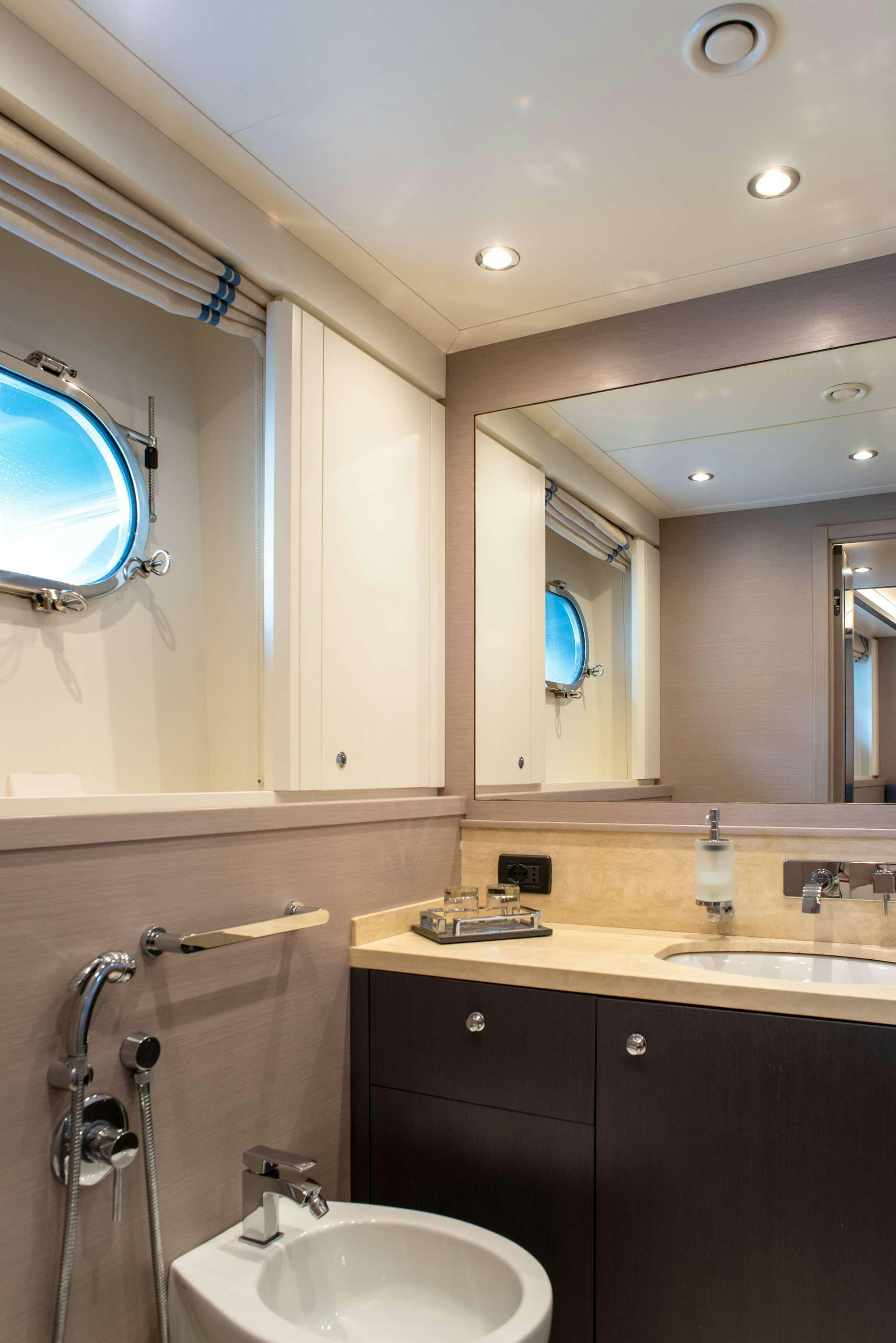 a bathroom with a sink and a mirror aboard GRANIL Yacht for Charter