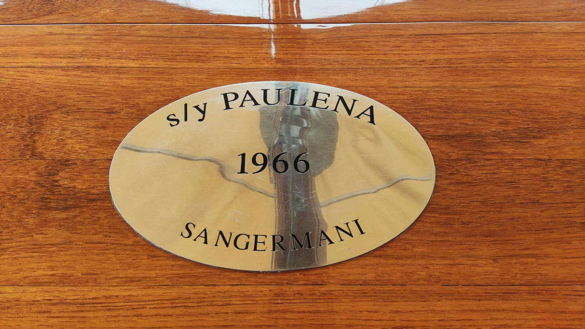 a circular white plate with a picture of a dog on it aboard PAULENA Yacht for Charter