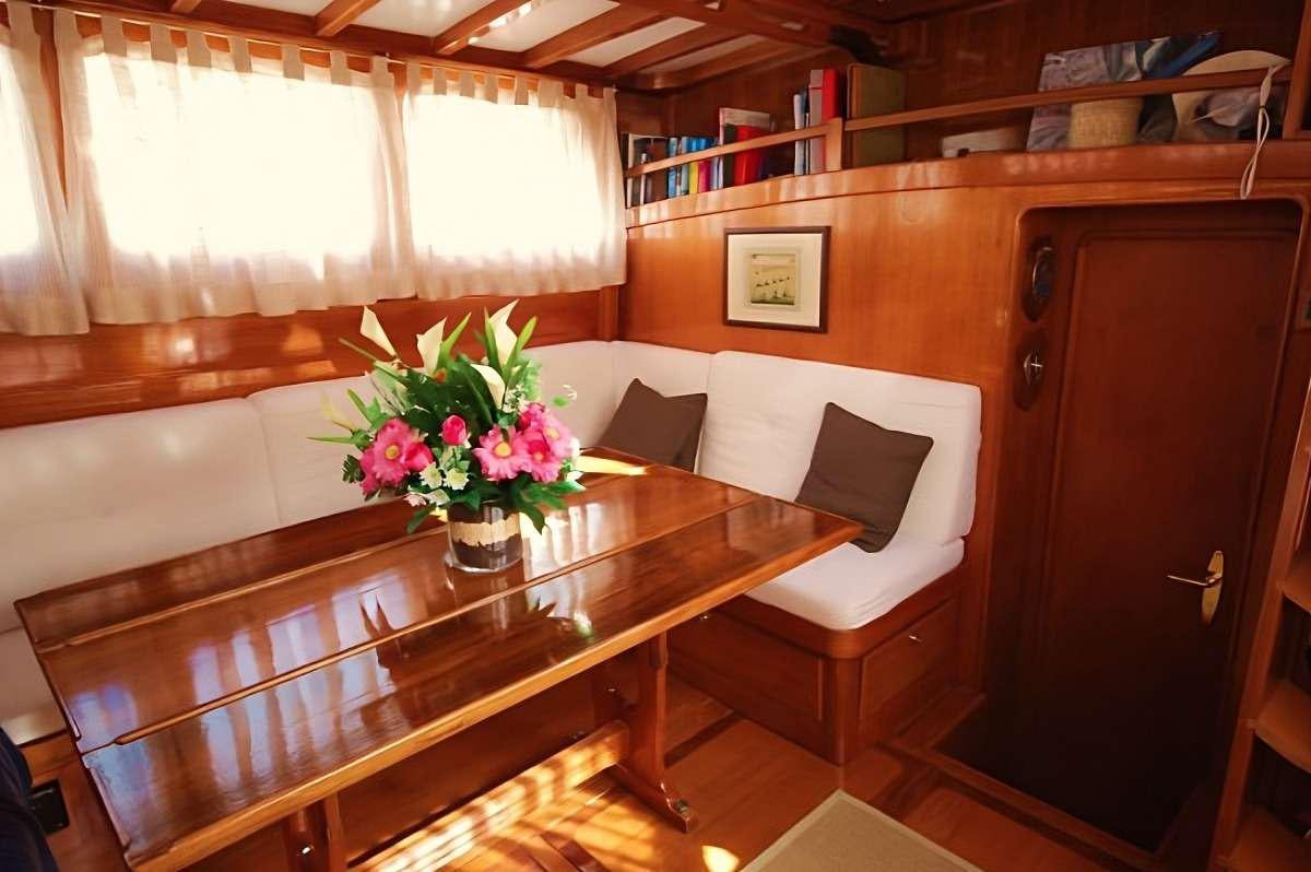 a room with a table and chairs aboard PAULENA Yacht for Charter
