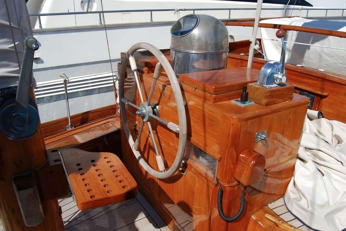 a wooden boat with a metal barrel aboard PAULENA Yacht for Charter