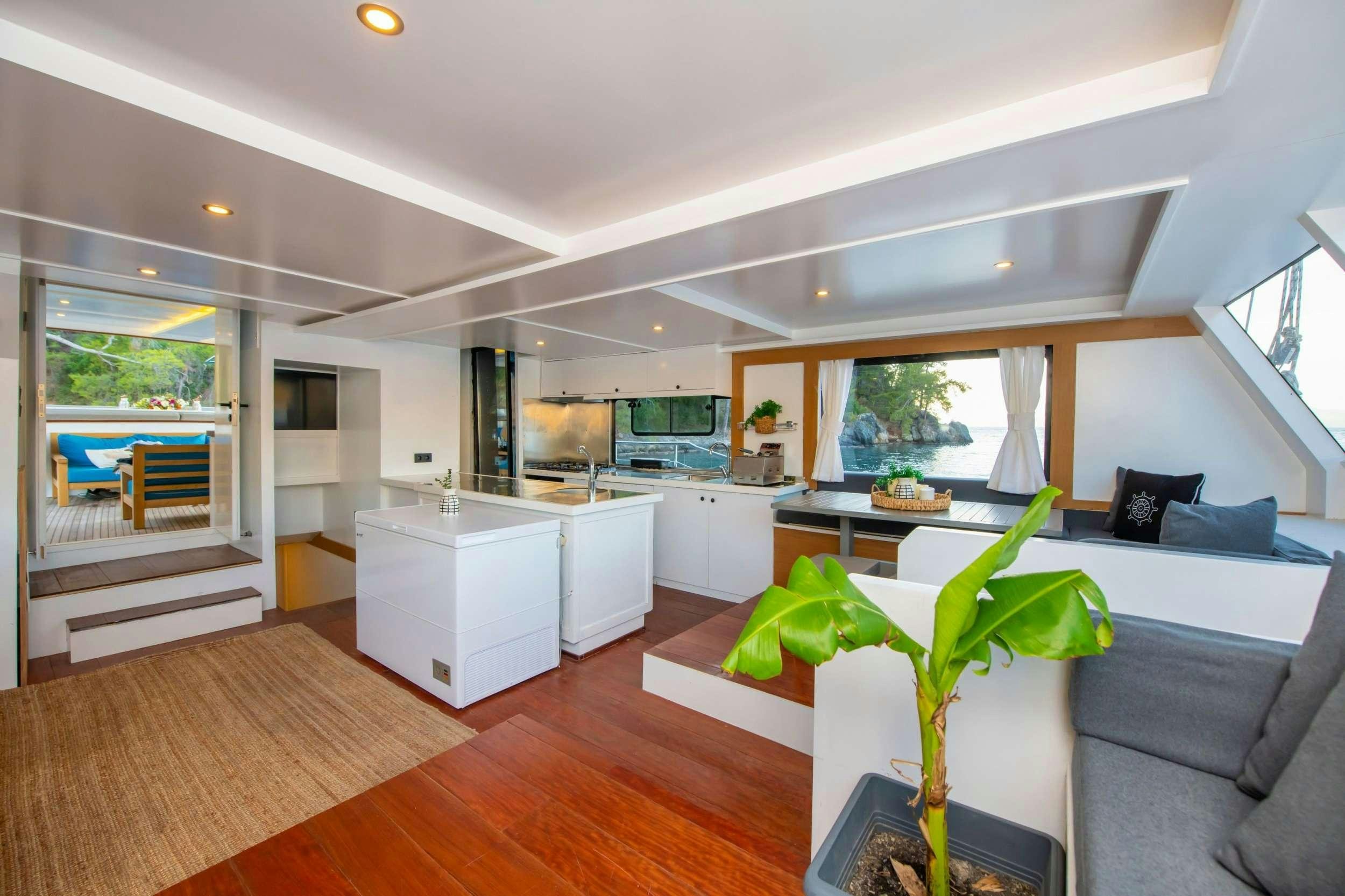 a living room with a plant aboard NAYK 2 Yacht for Charter