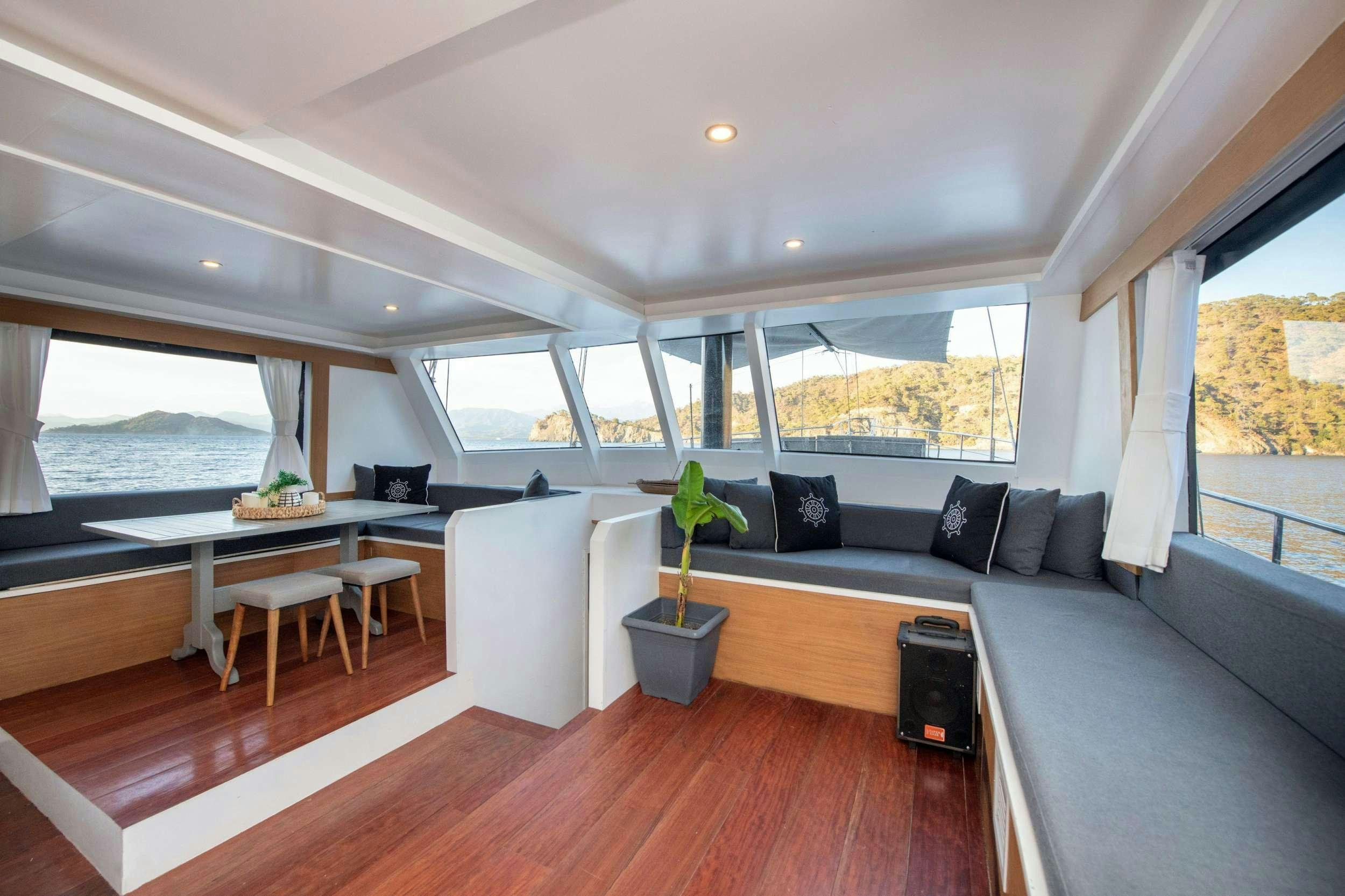 a living room with a couch and a table aboard NAYK 2 Yacht for Charter