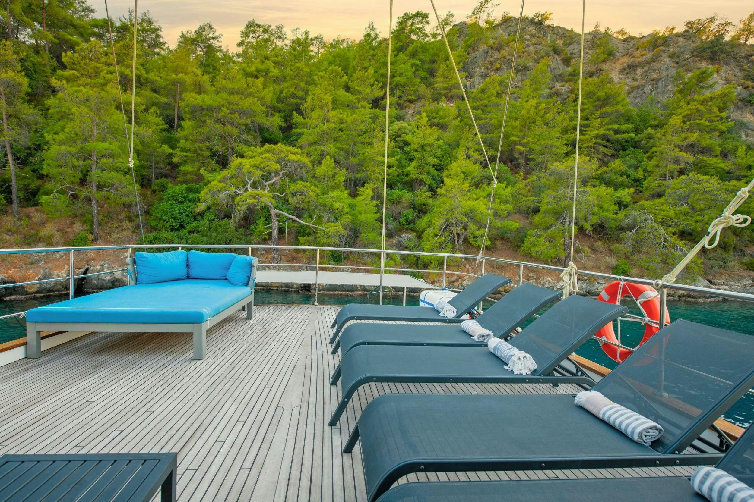 a pool with a deck and trees in the background aboard NAYK 2 Yacht for Charter