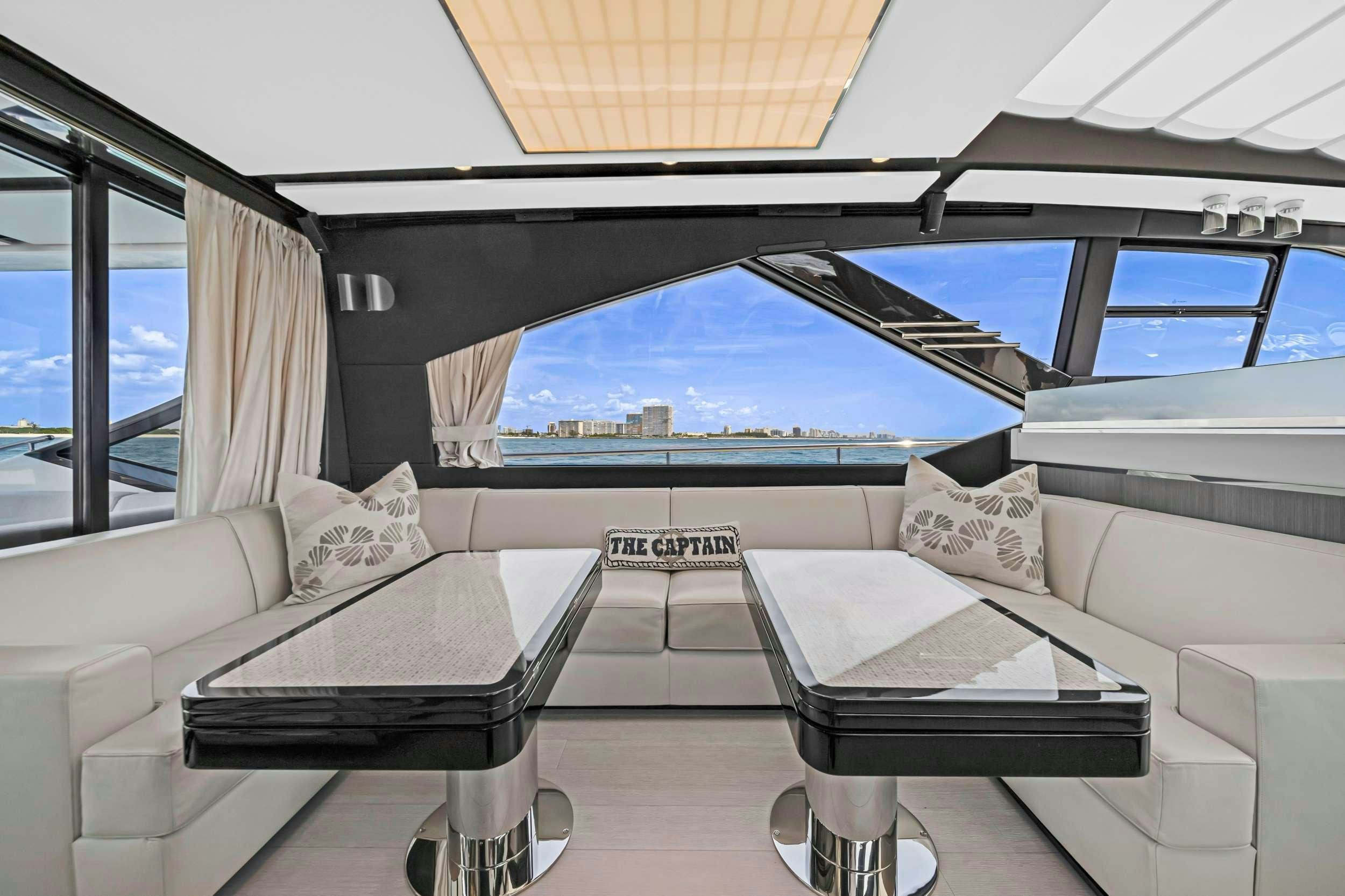 a room with a couch and a table and a large umbrella aboard ANOTHER CHANCE II Yacht for Charter