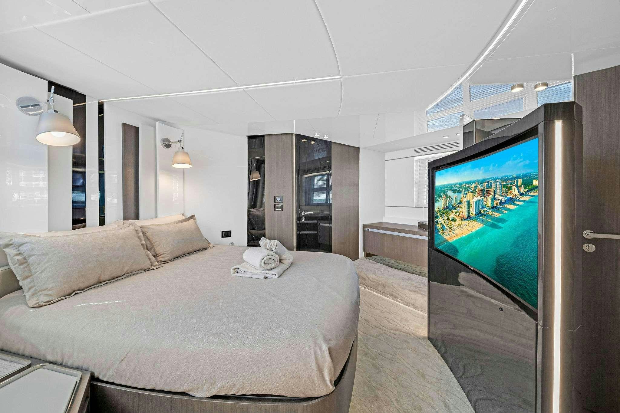 a bedroom with a bed and a tv aboard ANOTHER CHANCE II Yacht for Charter