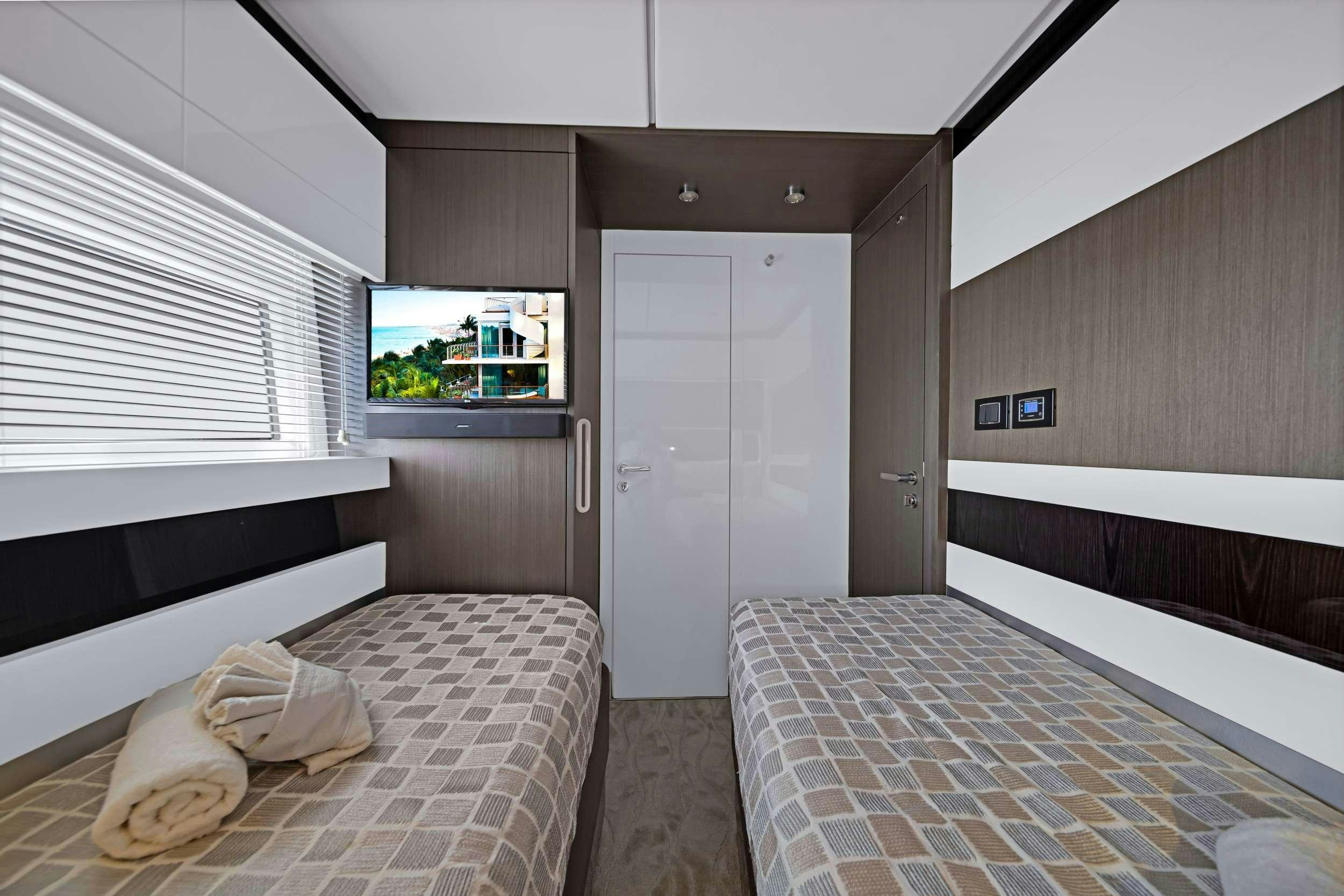 a room with a bed and a tv aboard ANOTHER CHANCE II Yacht for Charter