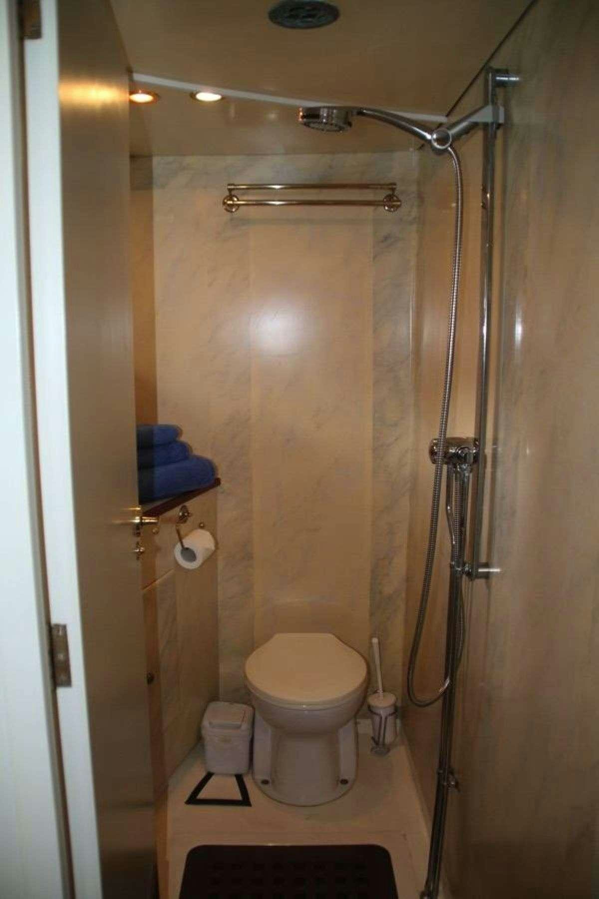a bathroom with a toilet and shower aboard WINDWEAVER OF PENNINGTON Yacht for Charter