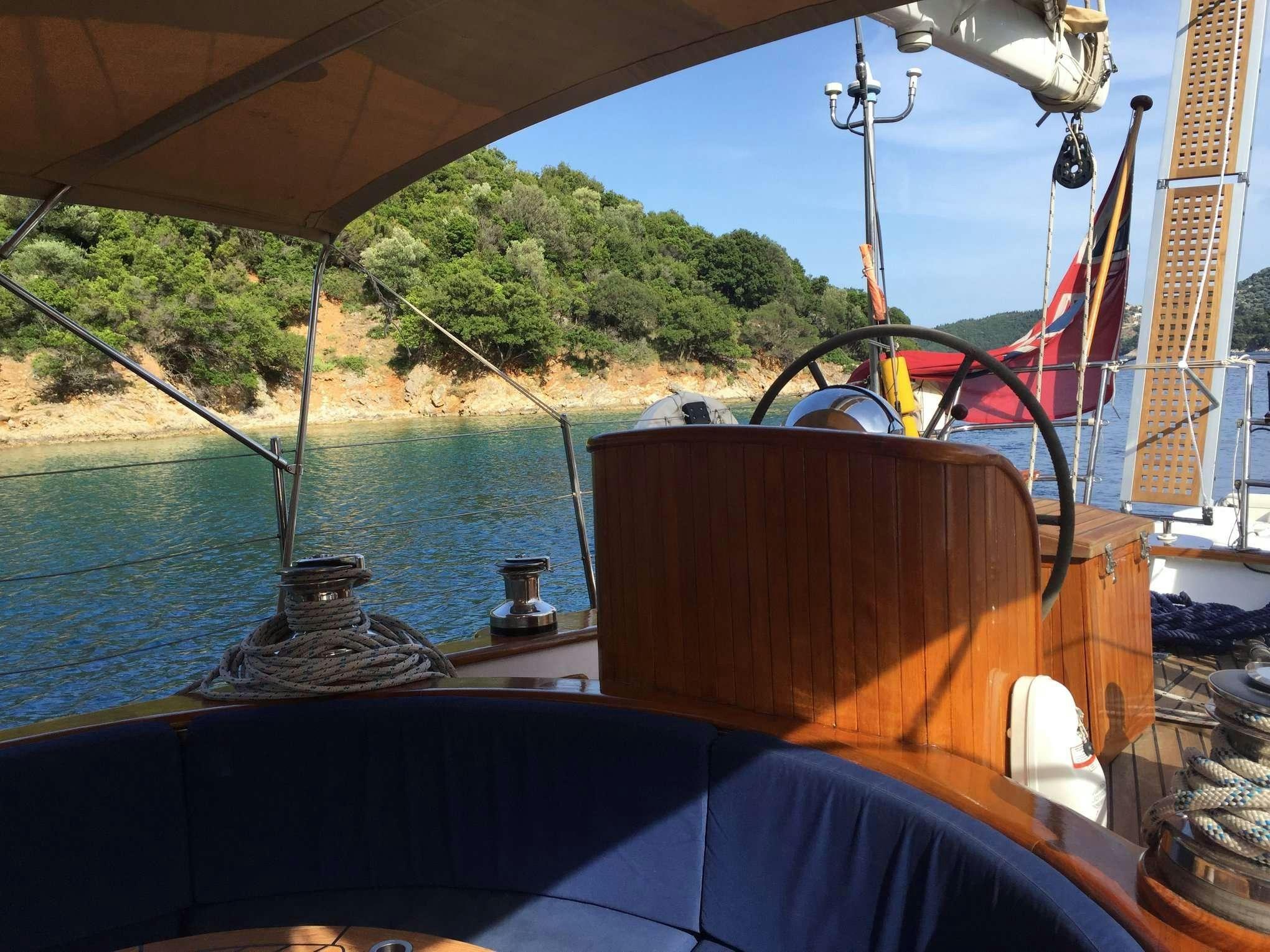 a boat with a water fountain and trees in the background aboard WINDWEAVER OF PENNINGTON Yacht for Charter