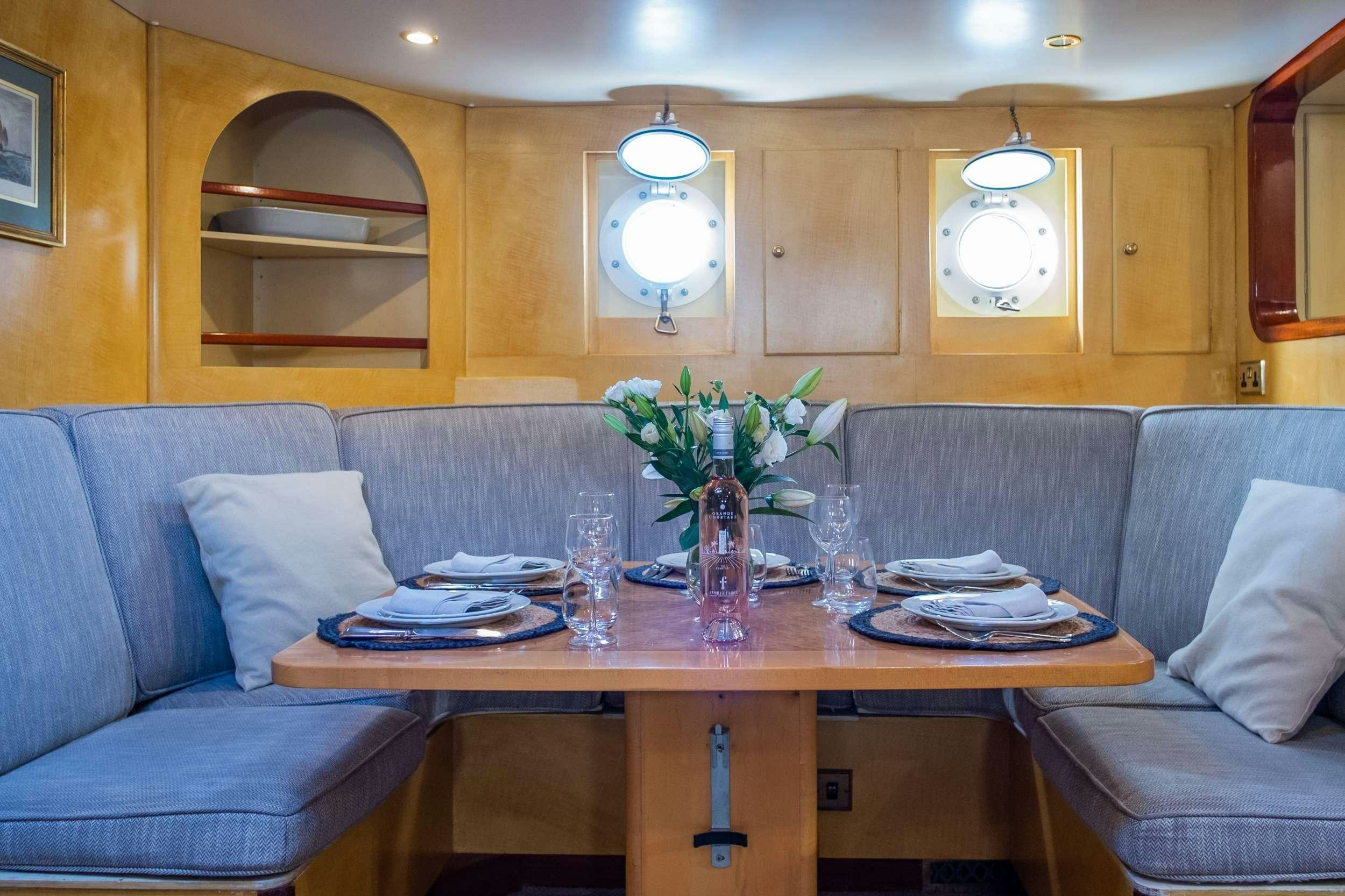 a living room with a couch and a table aboard WINDWEAVER OF PENNINGTON Yacht for Charter