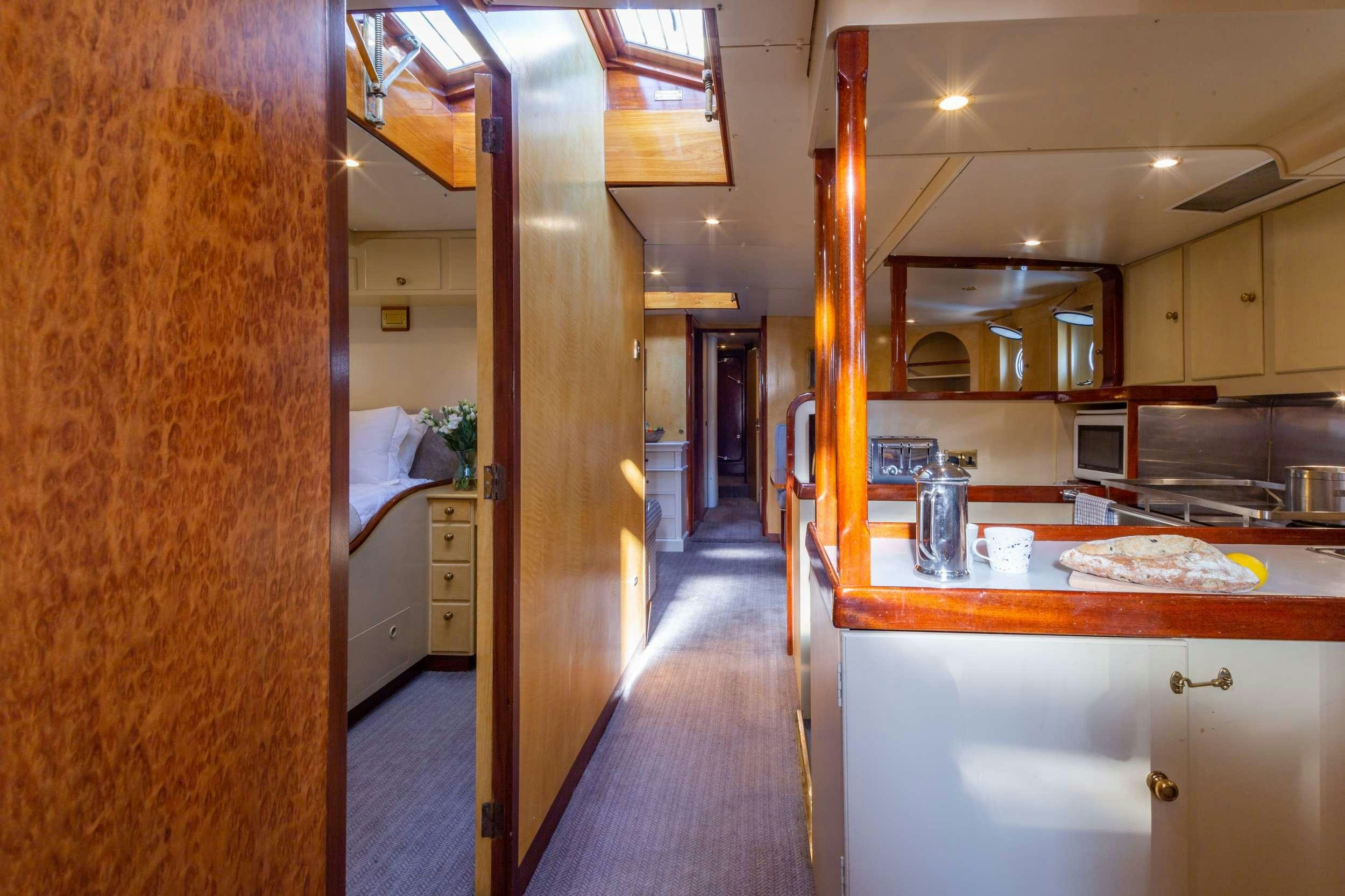 a kitchen with a large wooden door aboard WINDWEAVER OF PENNINGTON Yacht for Charter
