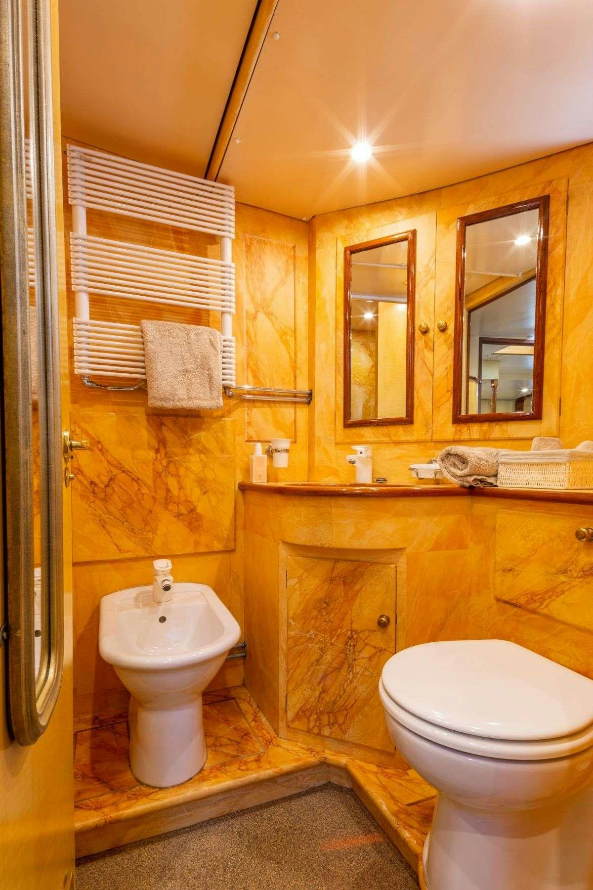 a bathroom with a toilet and a sink aboard WINDWEAVER OF PENNINGTON Yacht for Charter