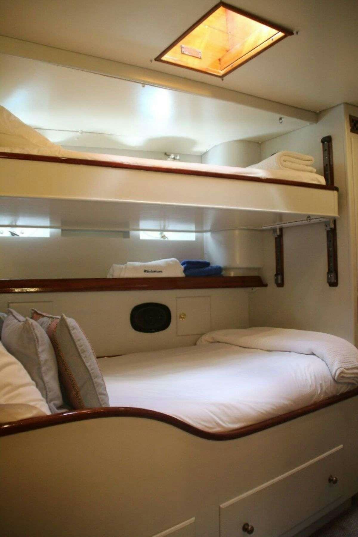 a room with a bed and a shelf aboard WINDWEAVER OF PENNINGTON Yacht for Charter