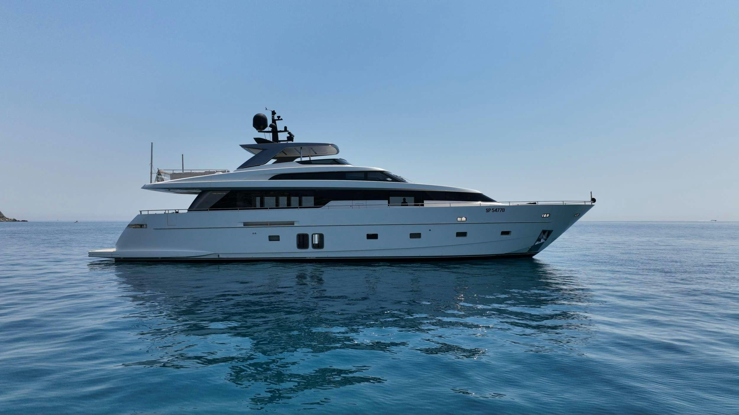 a white yacht in the water aboard AMAN Yacht for Charter