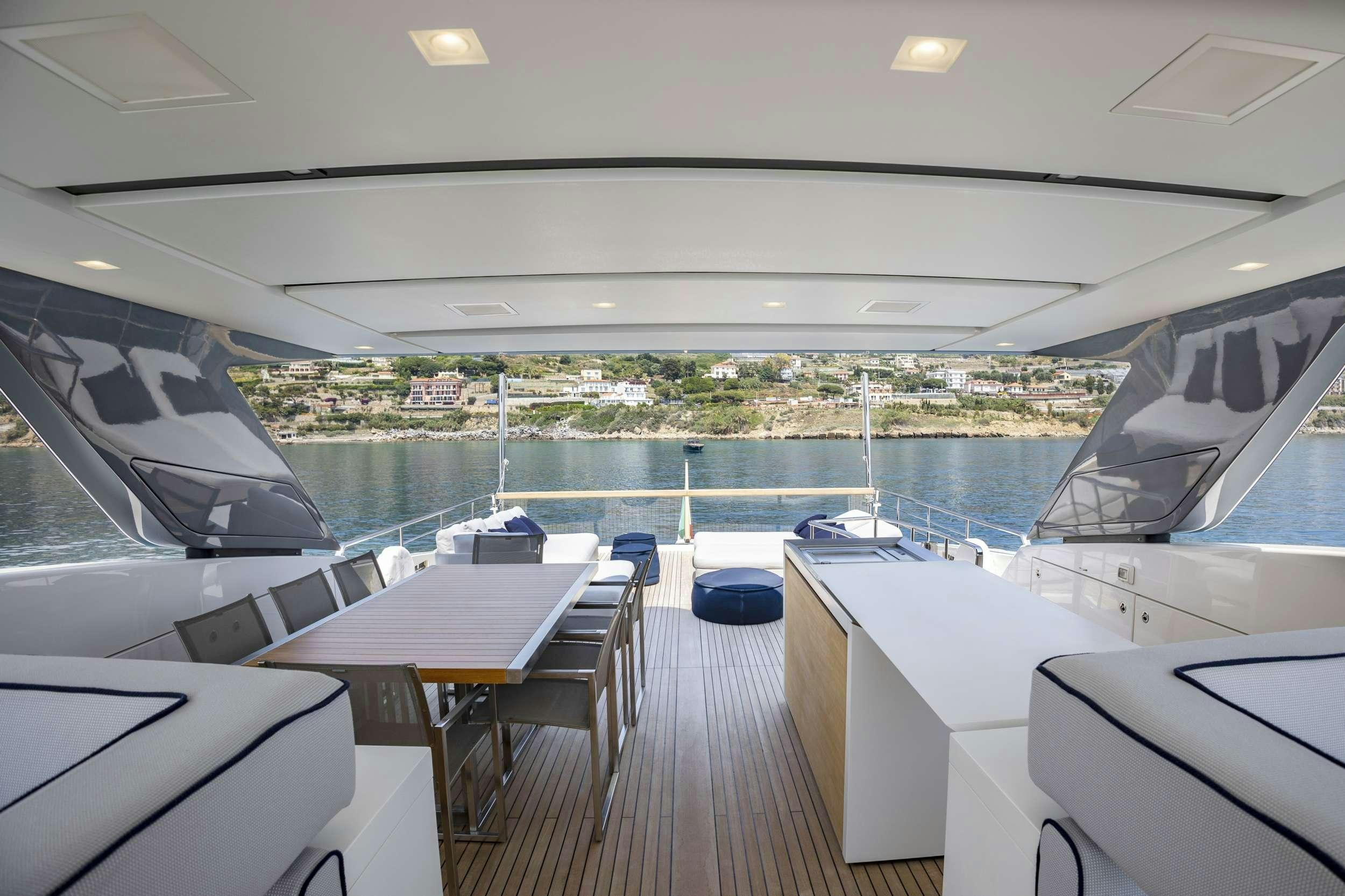 a deck with a view of a city and a body of water aboard AMAN Yacht for Charter