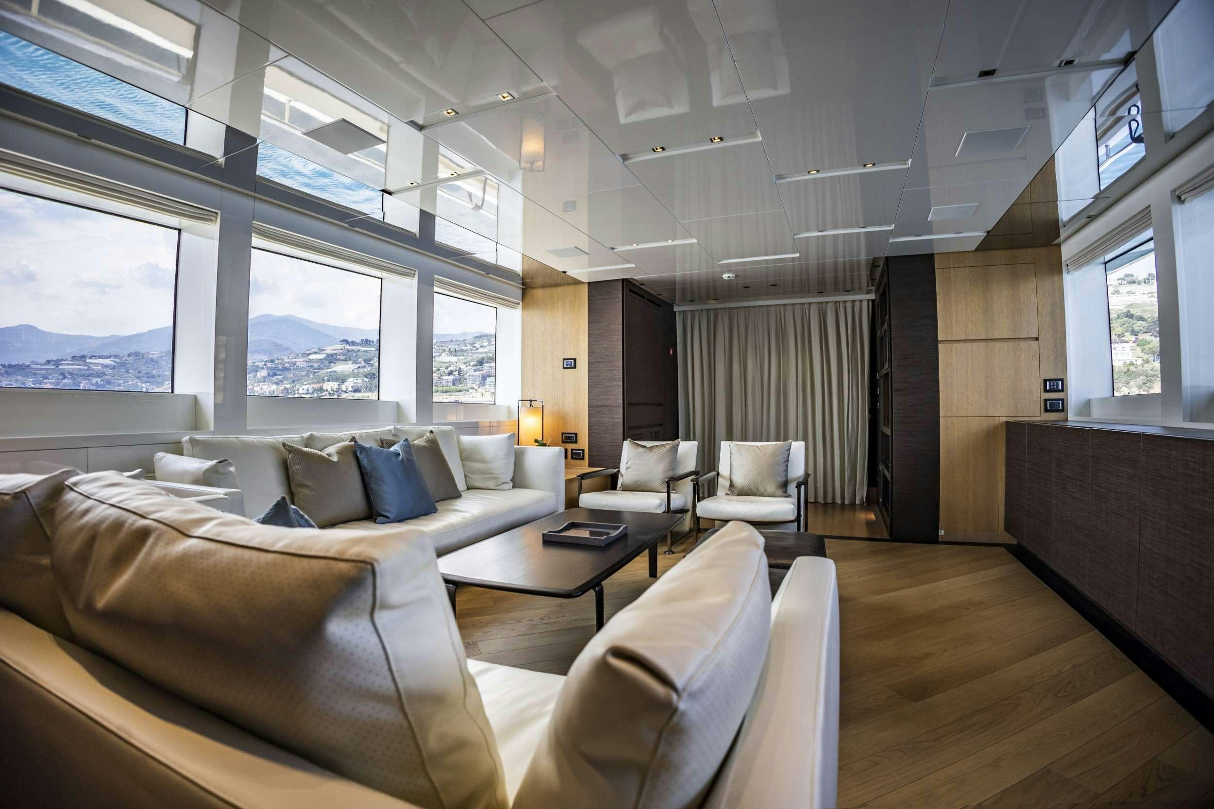 a room with couches and a table aboard AMAN Yacht for Charter