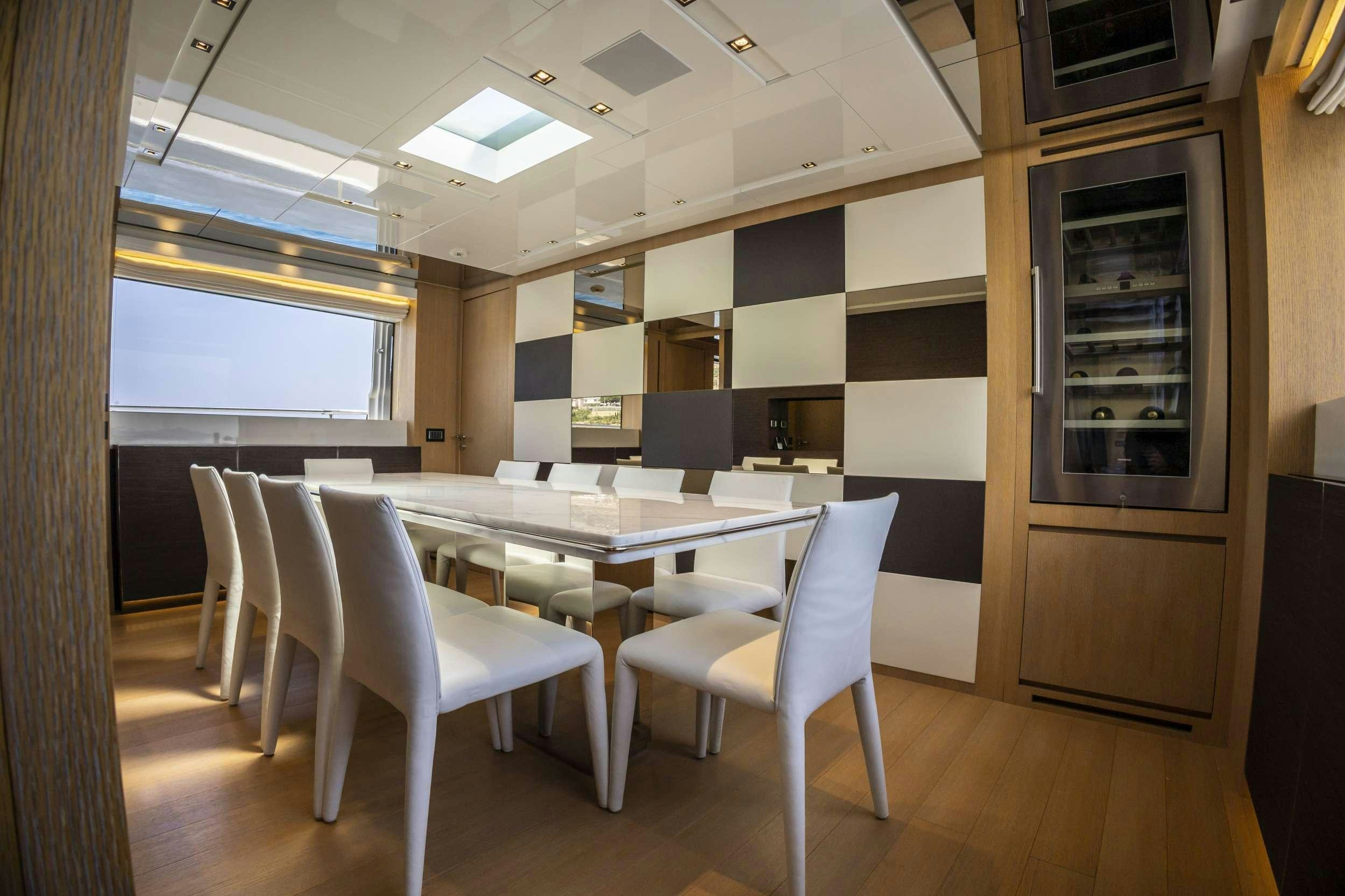 a room with a table and chairs aboard AMAN Yacht for Charter