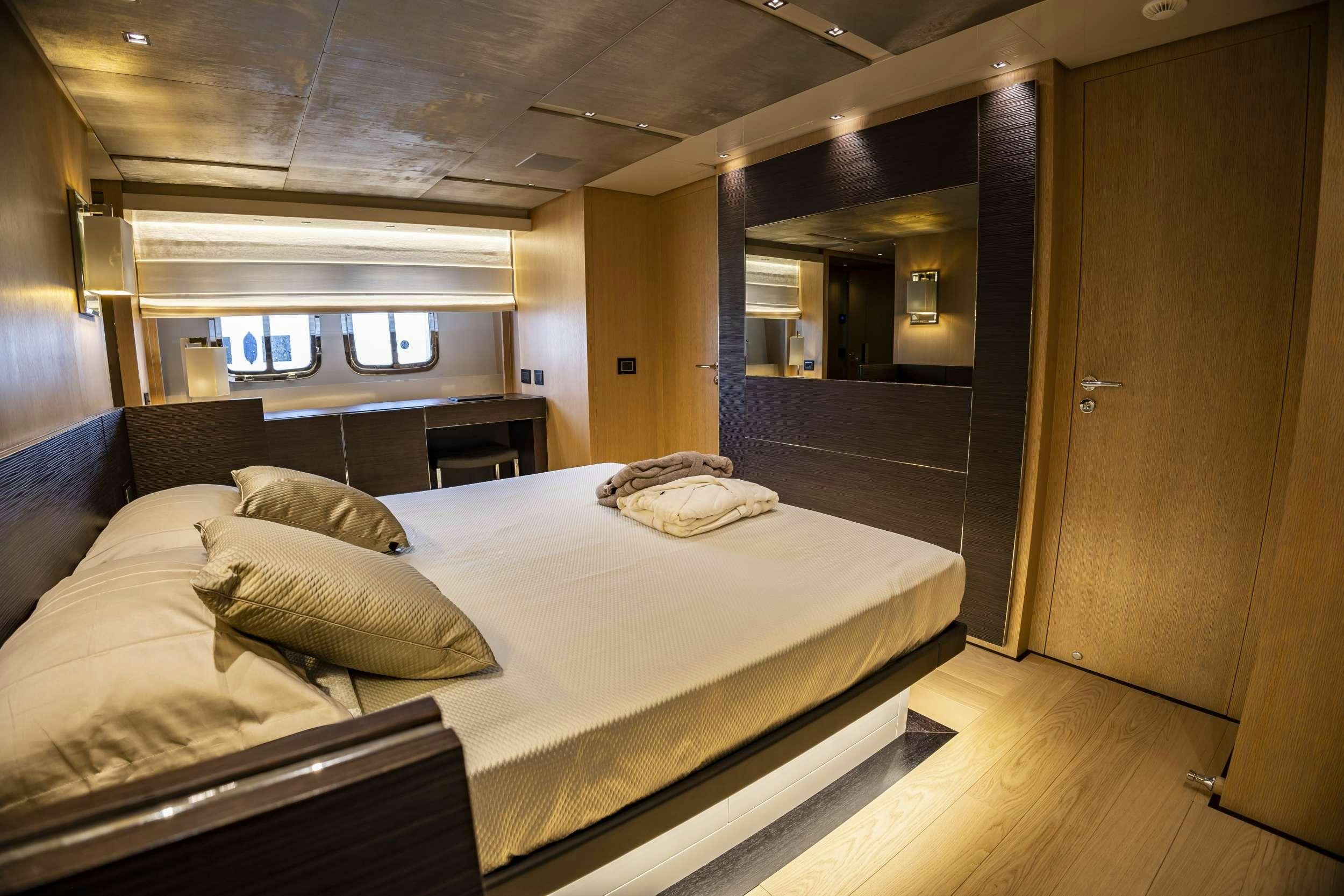 a room with a bed and a wood door aboard AMAN Yacht for Charter