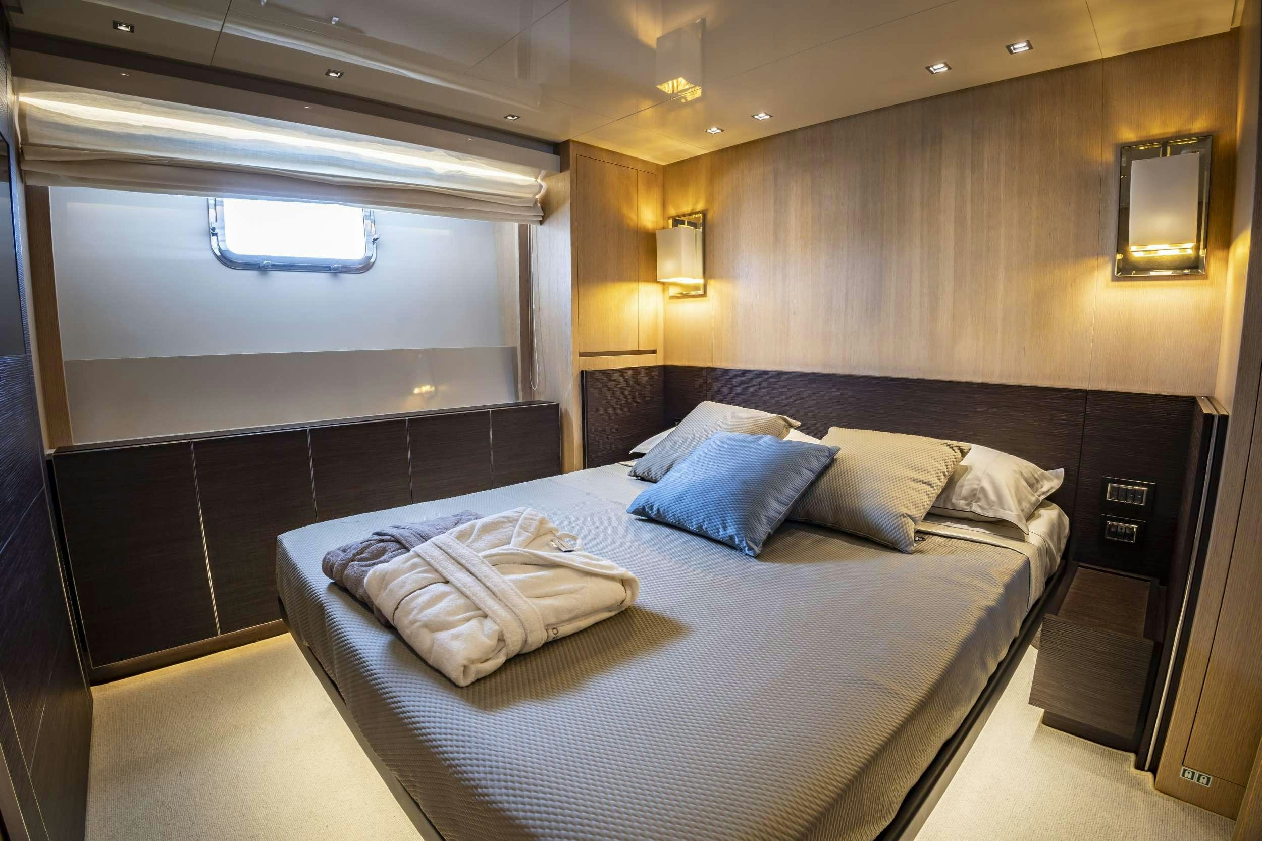 a bed in a room aboard AMAN Yacht for Charter