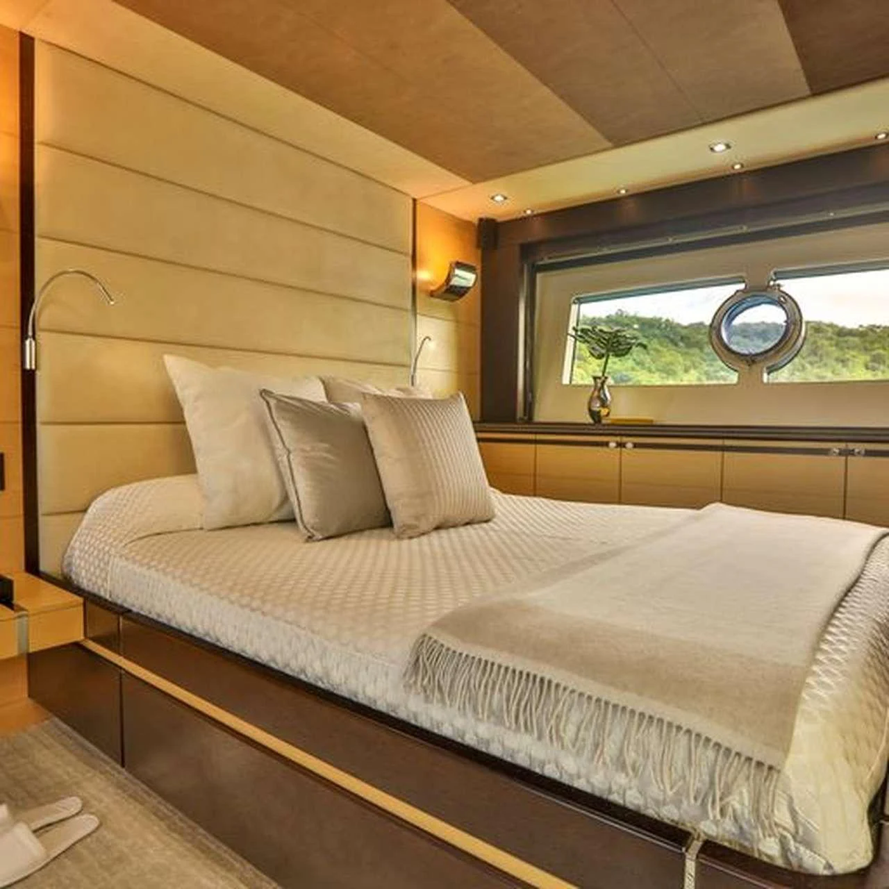 a bed with a white sheet and pillows aboard COSTASOL Yacht for Charter