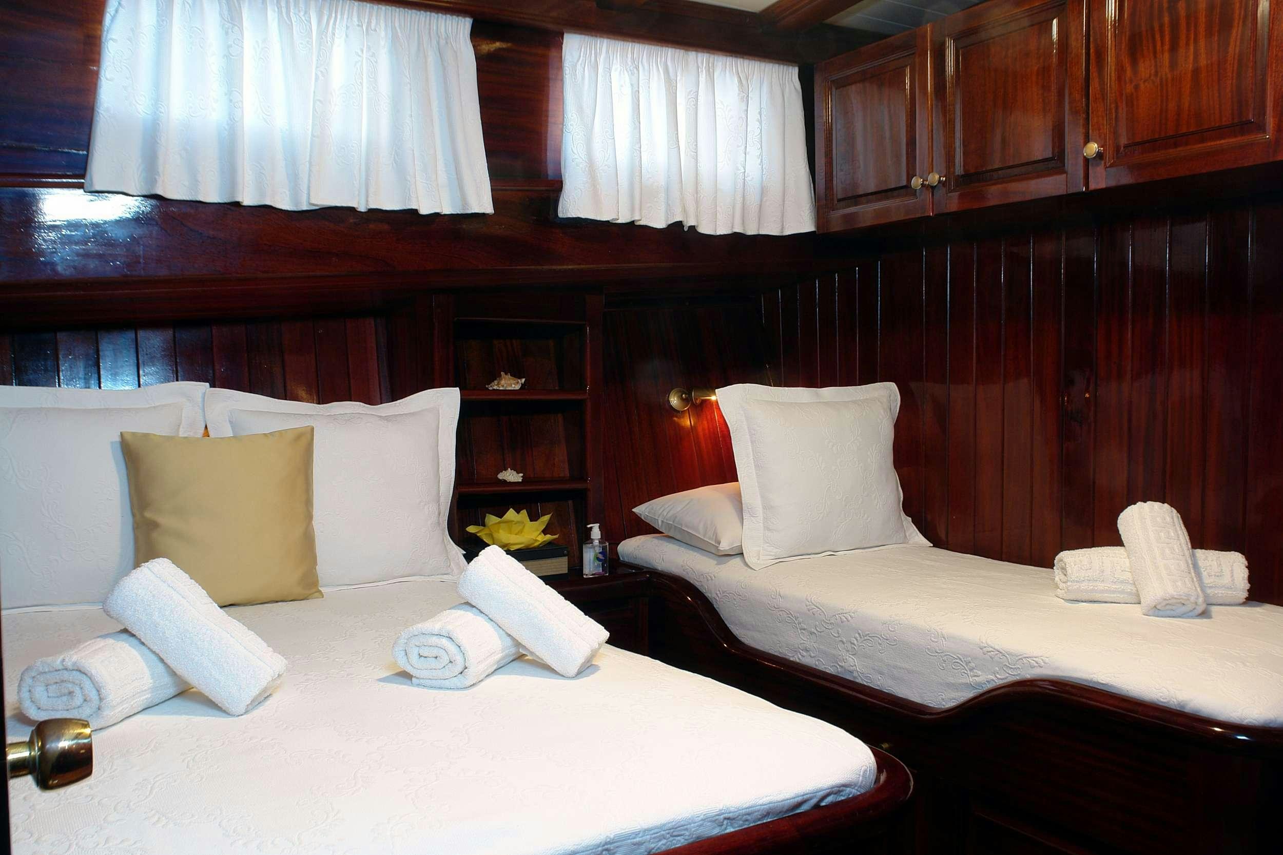 a room with two beds aboard ERATO Yacht for Charter