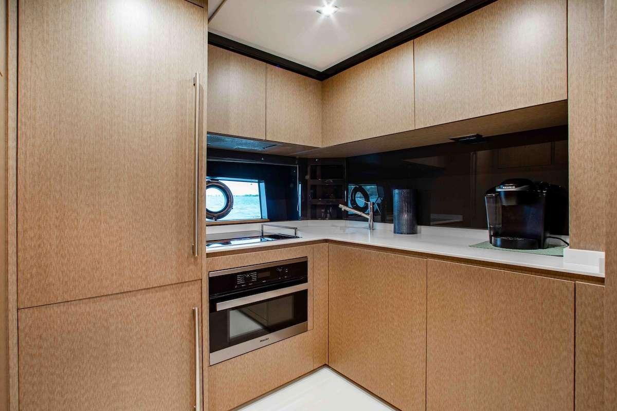 a kitchen with wooden cabinets aboard 2QUICK Yacht for Charter