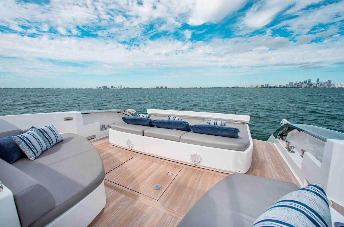 a deck with a pool table and a large city in the background aboard 2QUICK Yacht for Charter