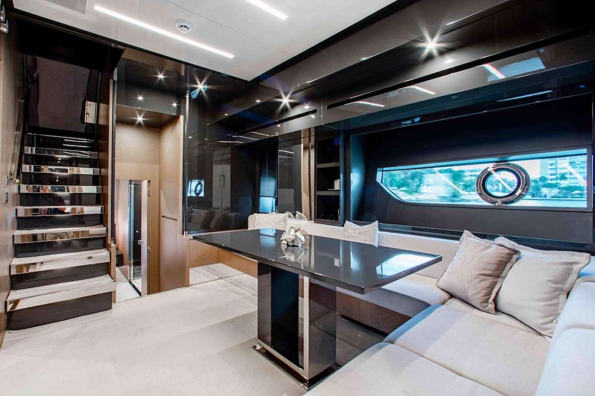 a room with a table and couch aboard 2QUICK Yacht for Charter