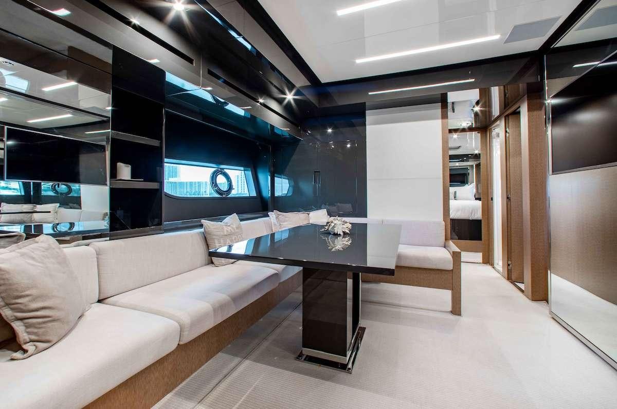 a room with a table and couch aboard 2QUICK Yacht for Charter