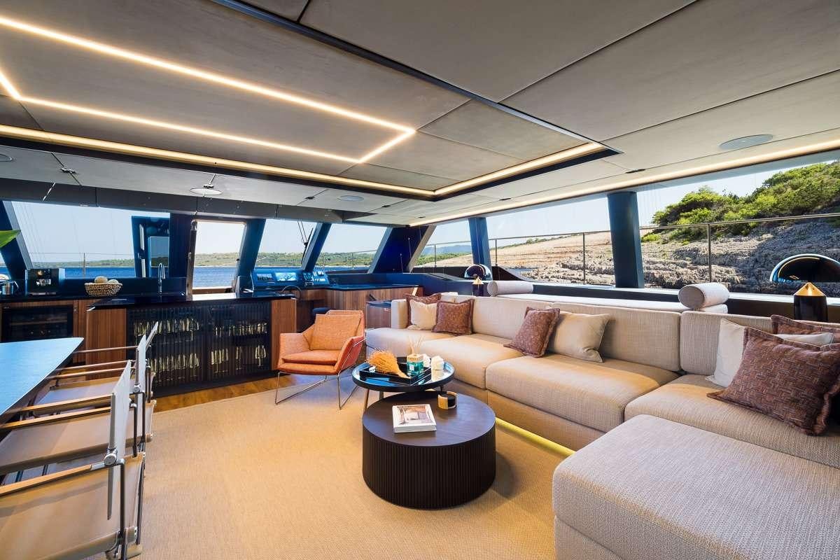 a living room with a large window aboard AMBER ONE Yacht for Charter
