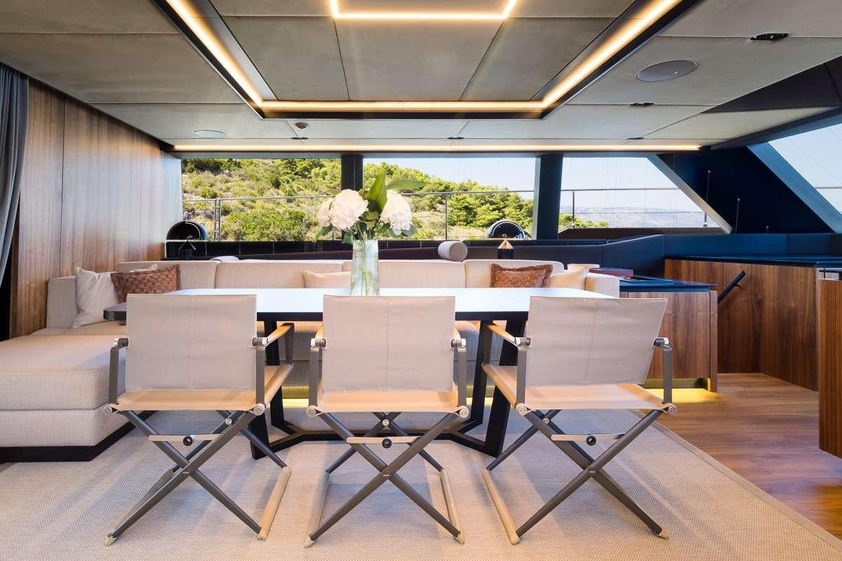 a room with chairs and tables aboard AMBER ONE Yacht for Charter
