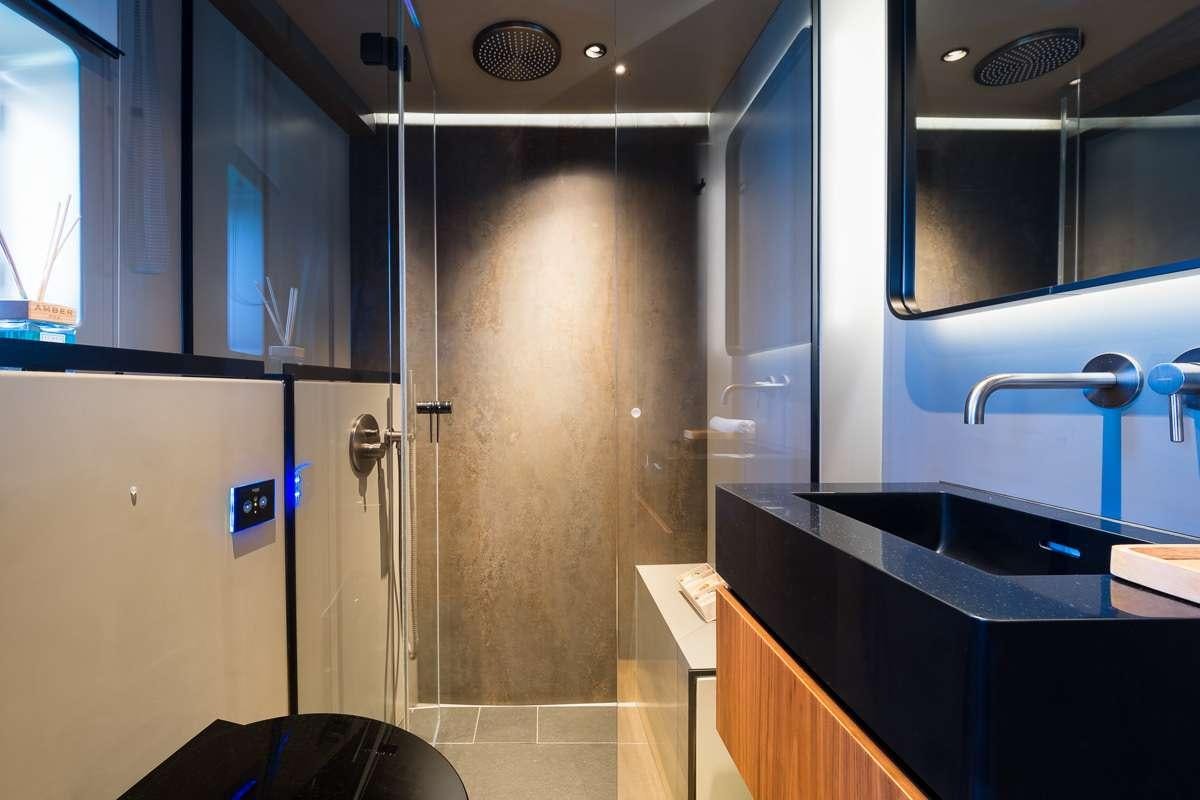 a bathroom with a shower and sink aboard AMBER ONE Yacht for Charter