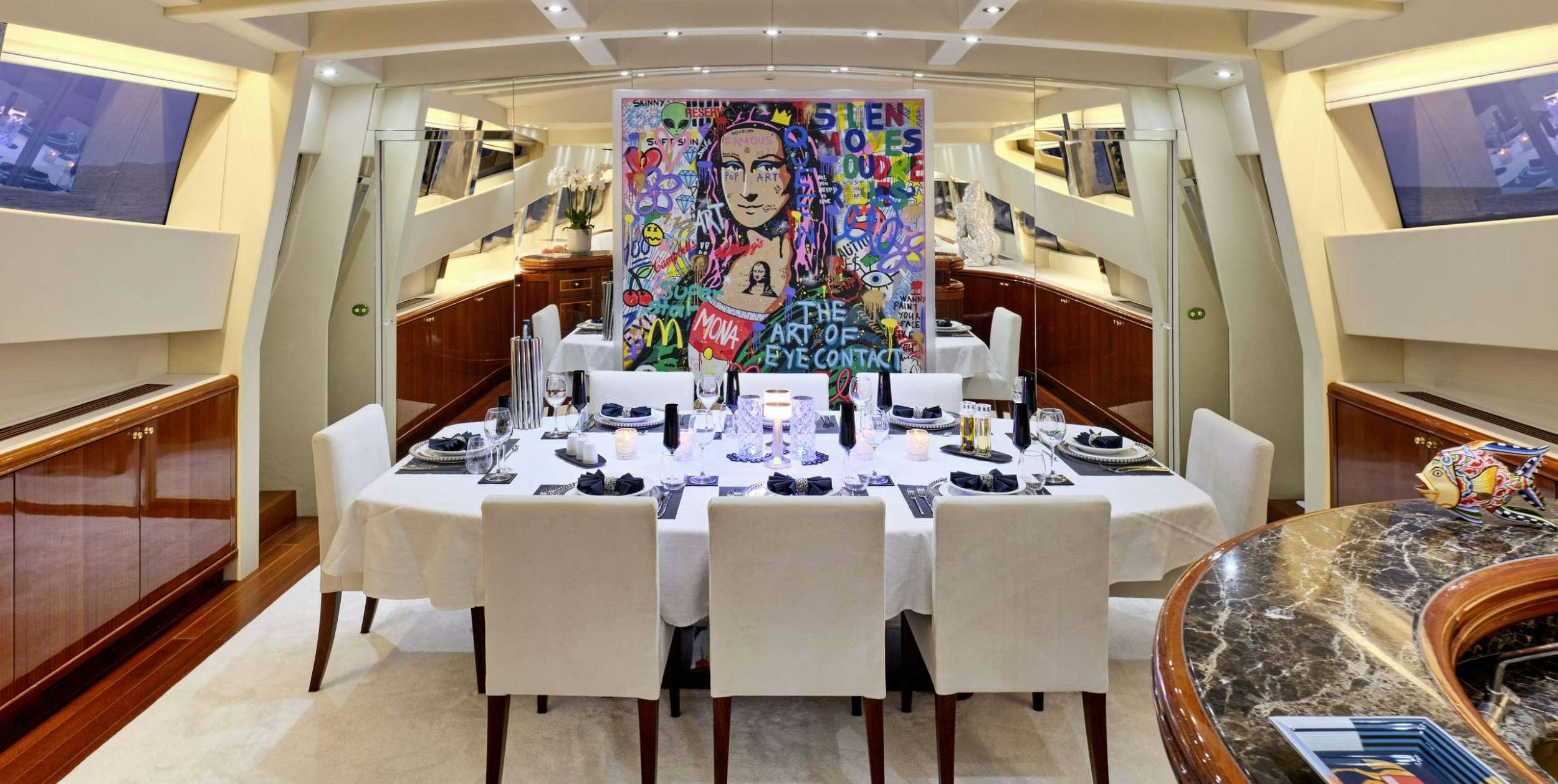 a large room with a table and chairs aboard ABILITY Yacht for Charter