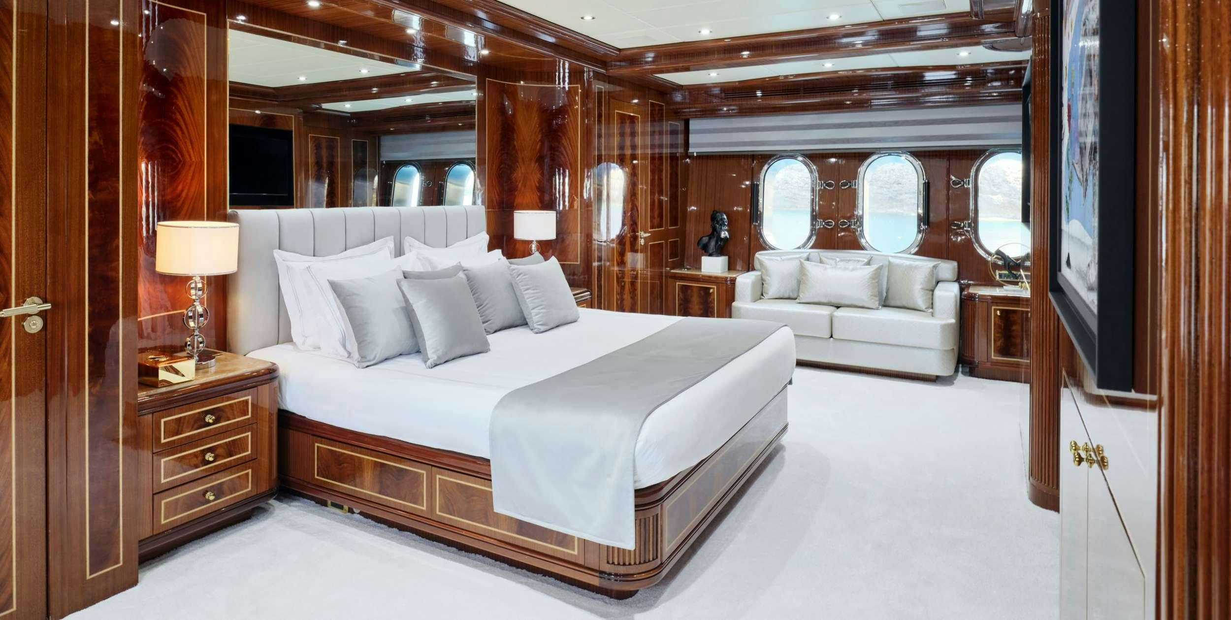a room with a bed and a television aboard ABILITY Yacht for Charter