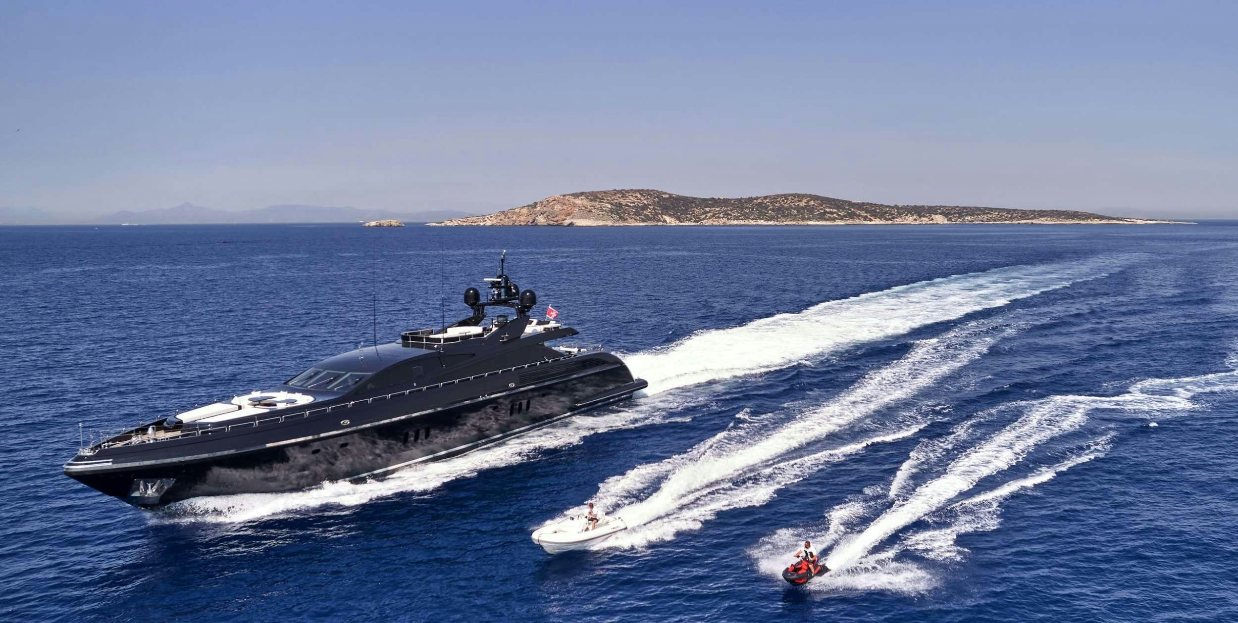 a large military ship in the water aboard ABILITY Yacht for Charter